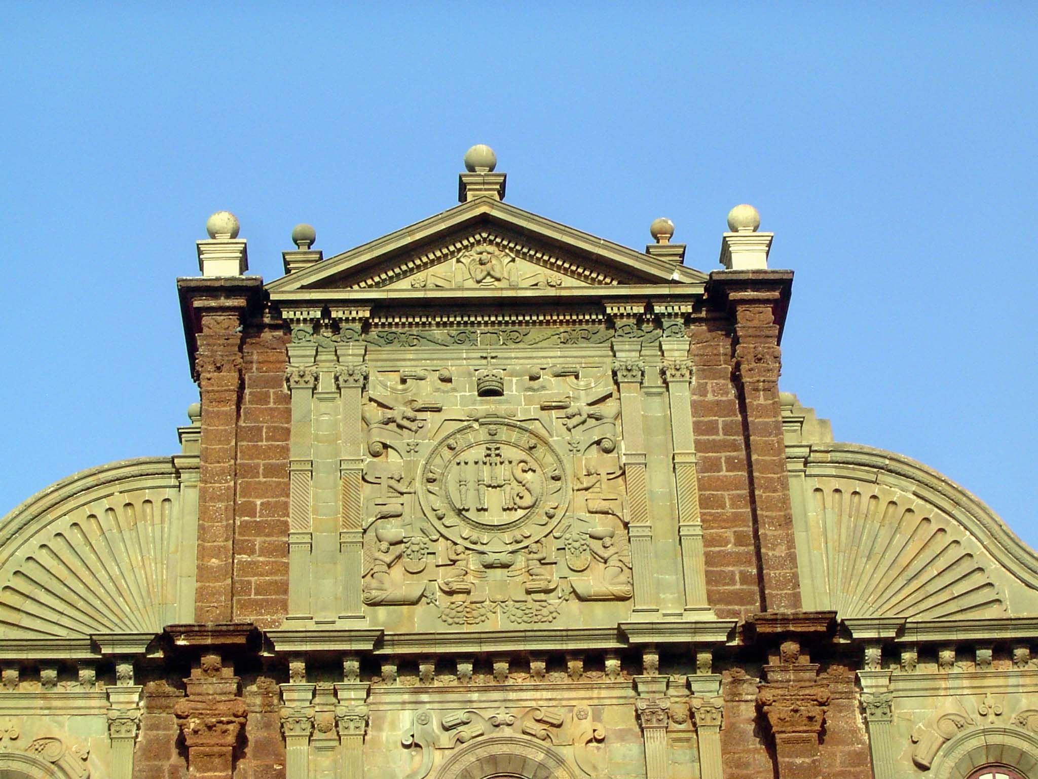 Top of the facade, with the Jesuit seal in granite.
