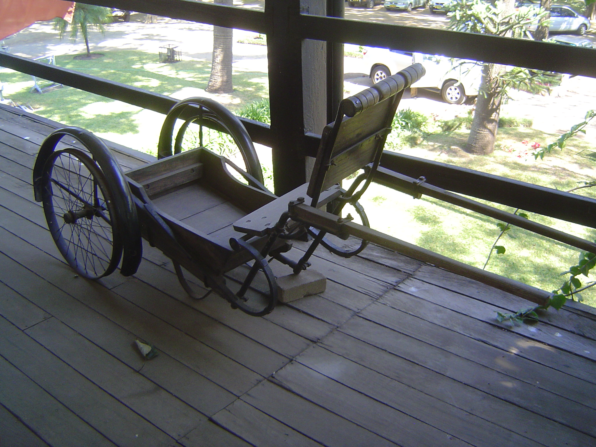 On the upstairs porch, a garetta. It's a ricksha of unusual design but an improvement on the machila, a kind of portable hammock used in the