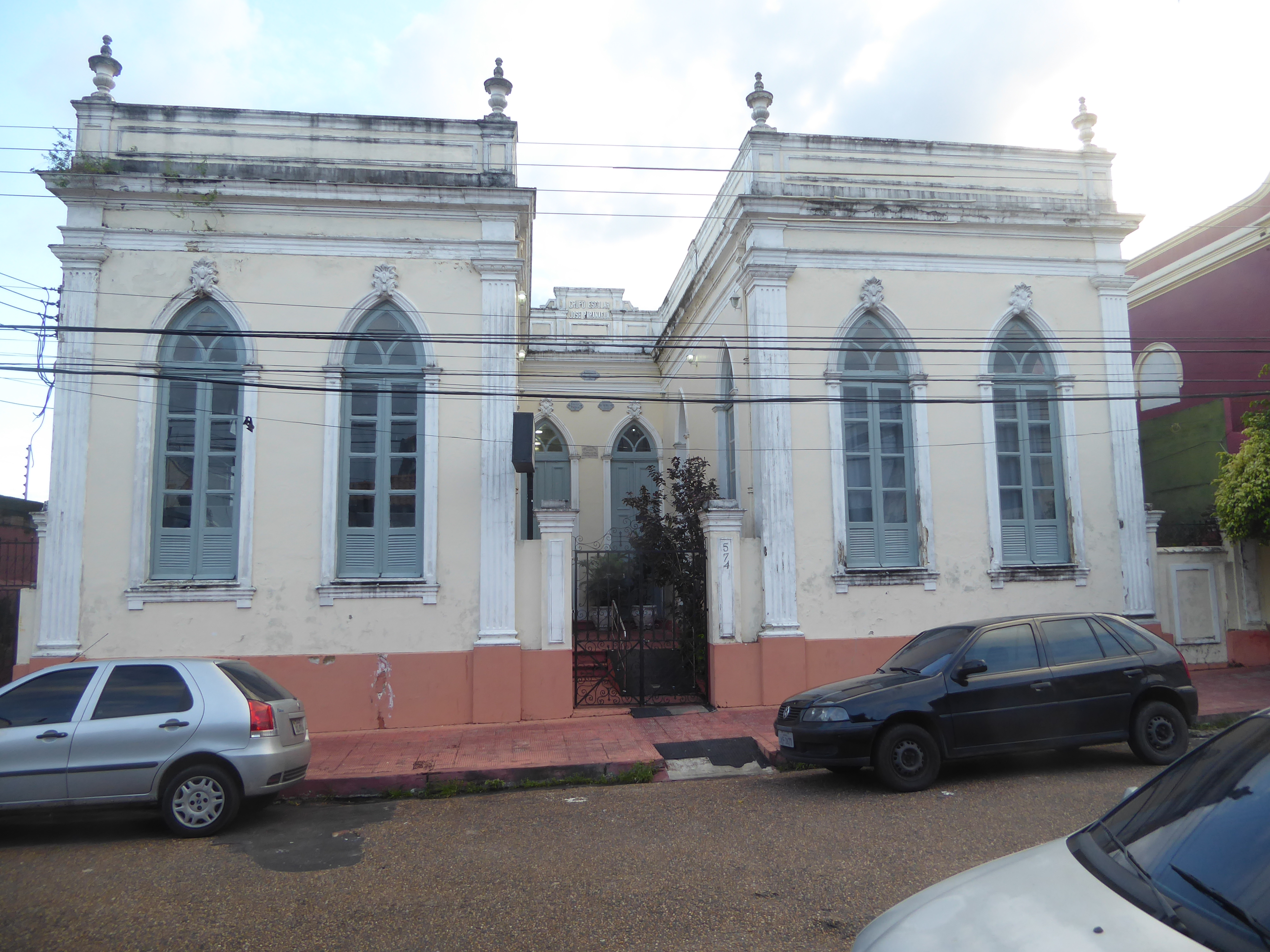 Here's a public school from 1895; it's close to the same Igarapé Educandos. When the local student population declined with slum clearance,