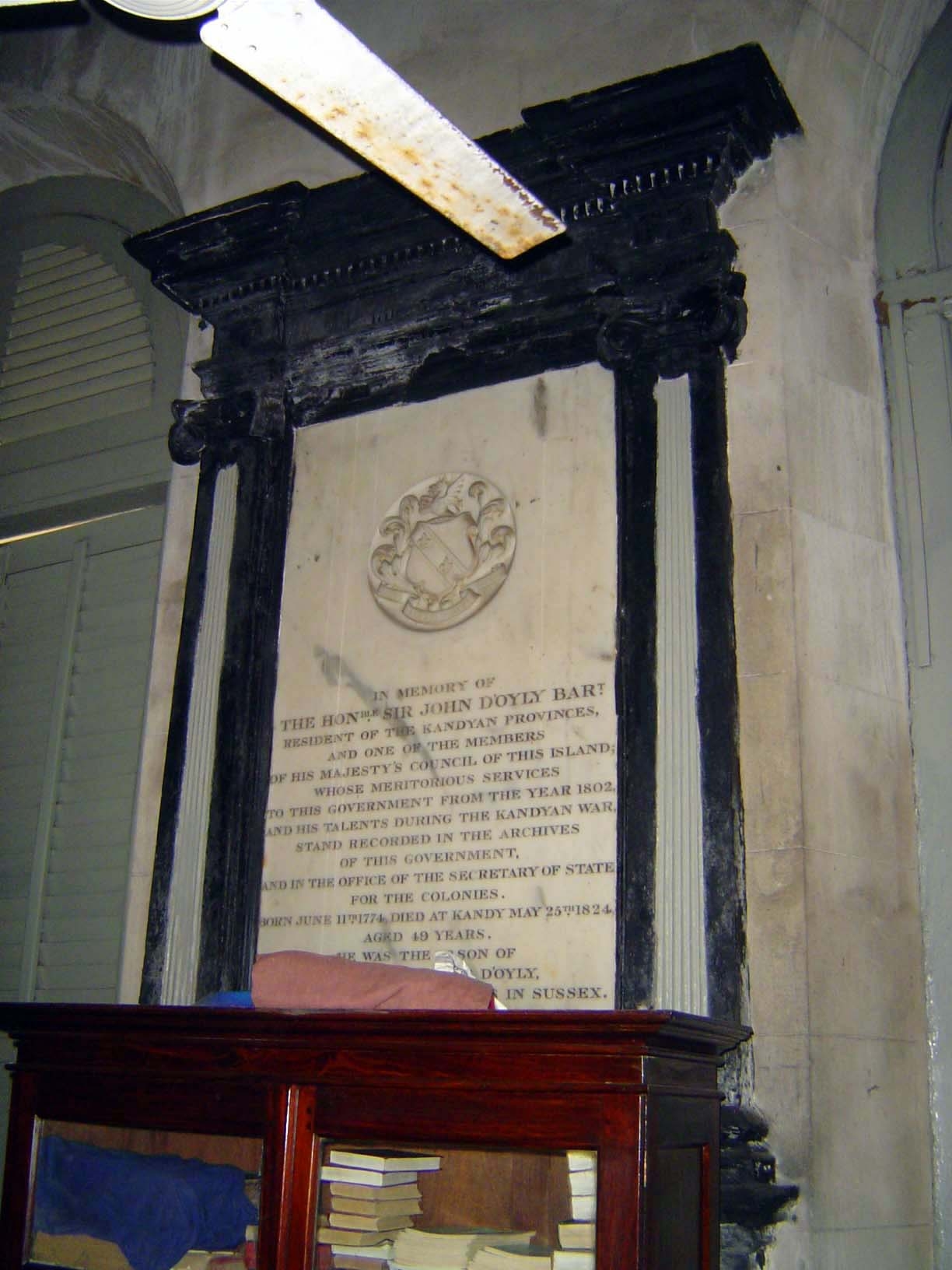 "In memory of the Hon. Sir John D'Oyly, Bart, Resident of the Kandyan Provinces, and one of the Members of H.M. Council of this Island, whos