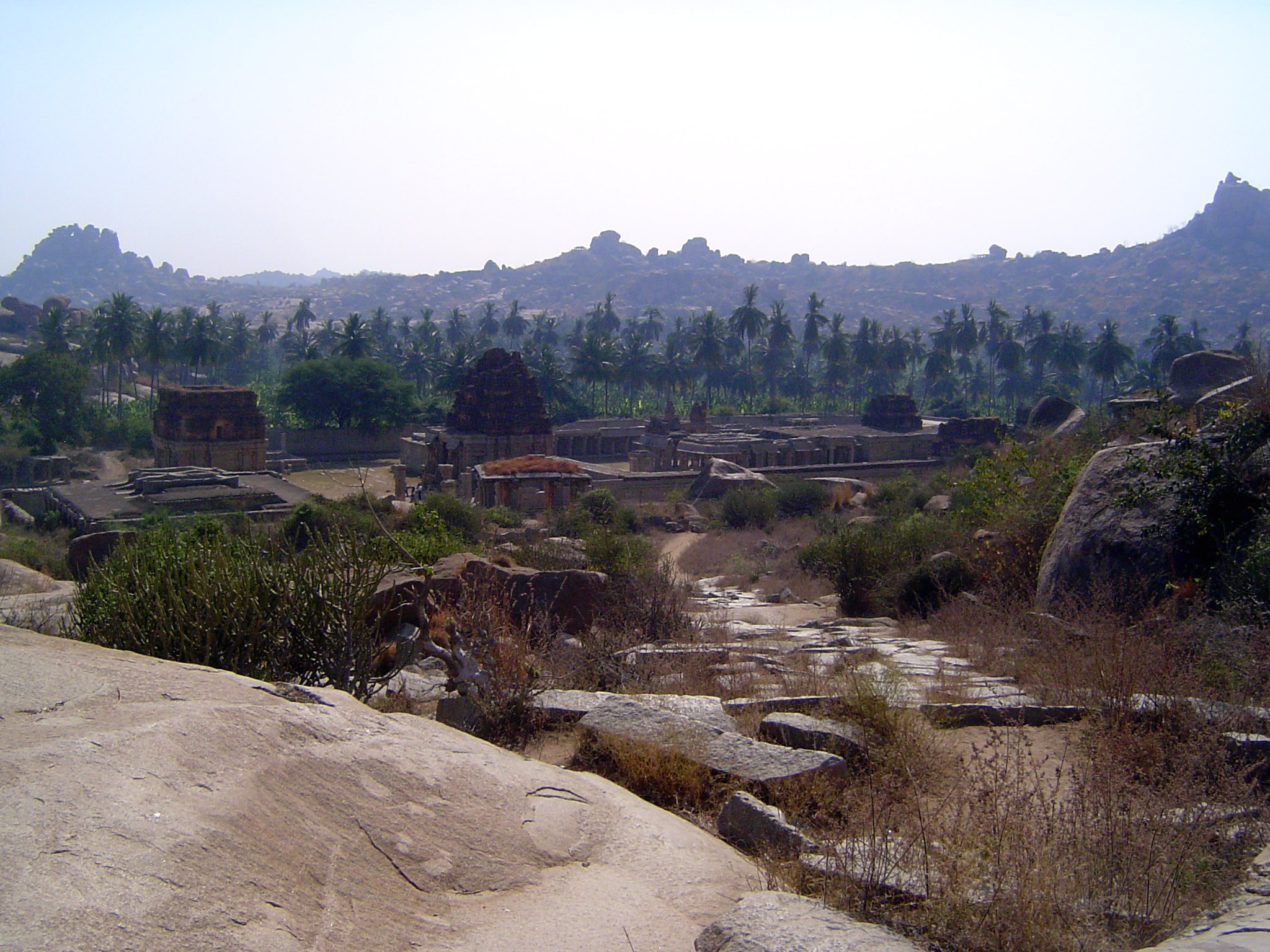 Over the pass, the view looks down on a desanctified temple named either for Tiruvengalanatha a form of Vishnu equivalent to Venkateshwar or