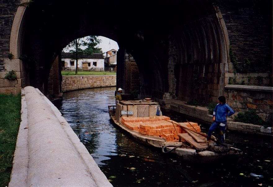 A load of bricks, driven by a noisy outboard motor.
