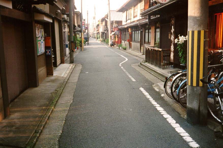 This lane has less character than the one in the previous picture, but it's more typical of Kyoto, whose street layout was imported from Tan