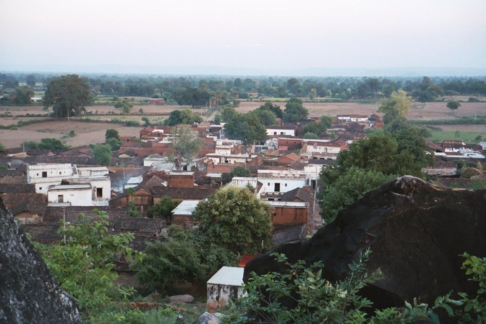 The village is at the toe of a granitic hill rising from a cultivated plain.