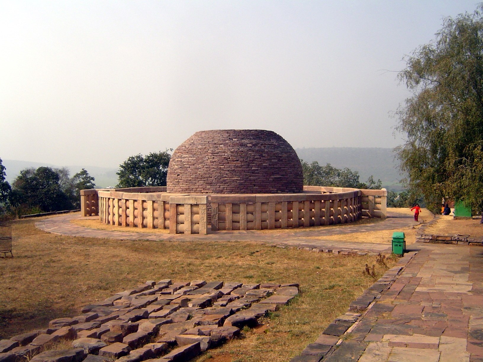 A thousand feet down the slope of the hill is Stupa 2, with relics from the approximate time of Ashoka. A sandstone relic casket with the na