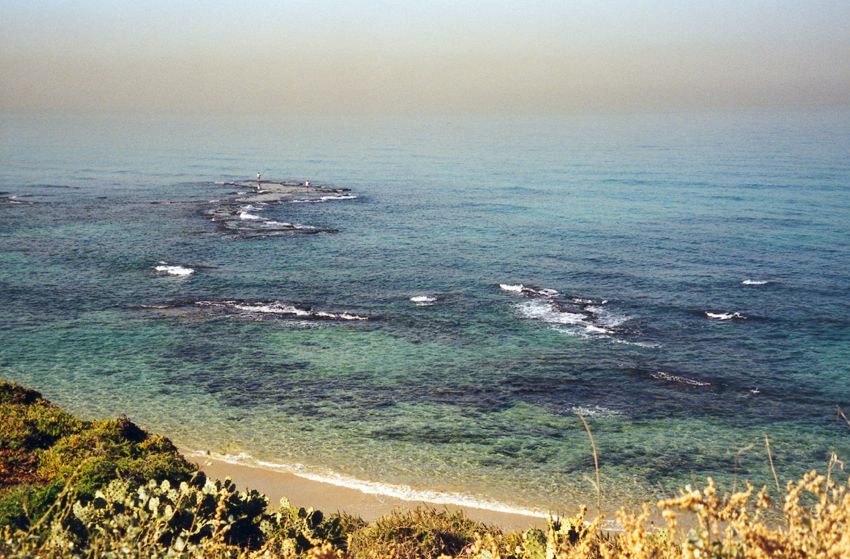 The hazy view from Jaffa west toward Andromeda's Rock. Through the 19th century, this was the very rough port of Palestine, with landings by