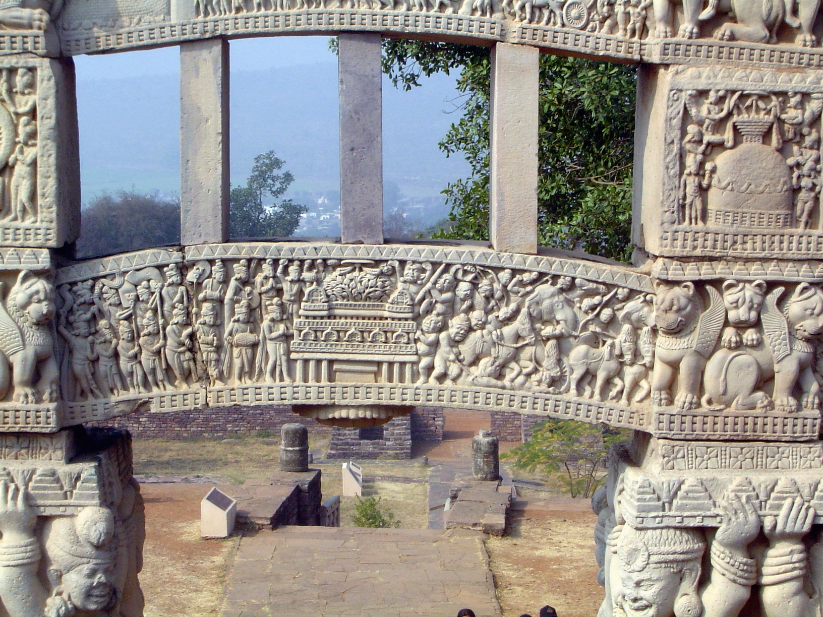 The bottom architrave according to Marshall and Fouchet shows a procession to the Bodhi tree; later interpreters see the moment of enlighten