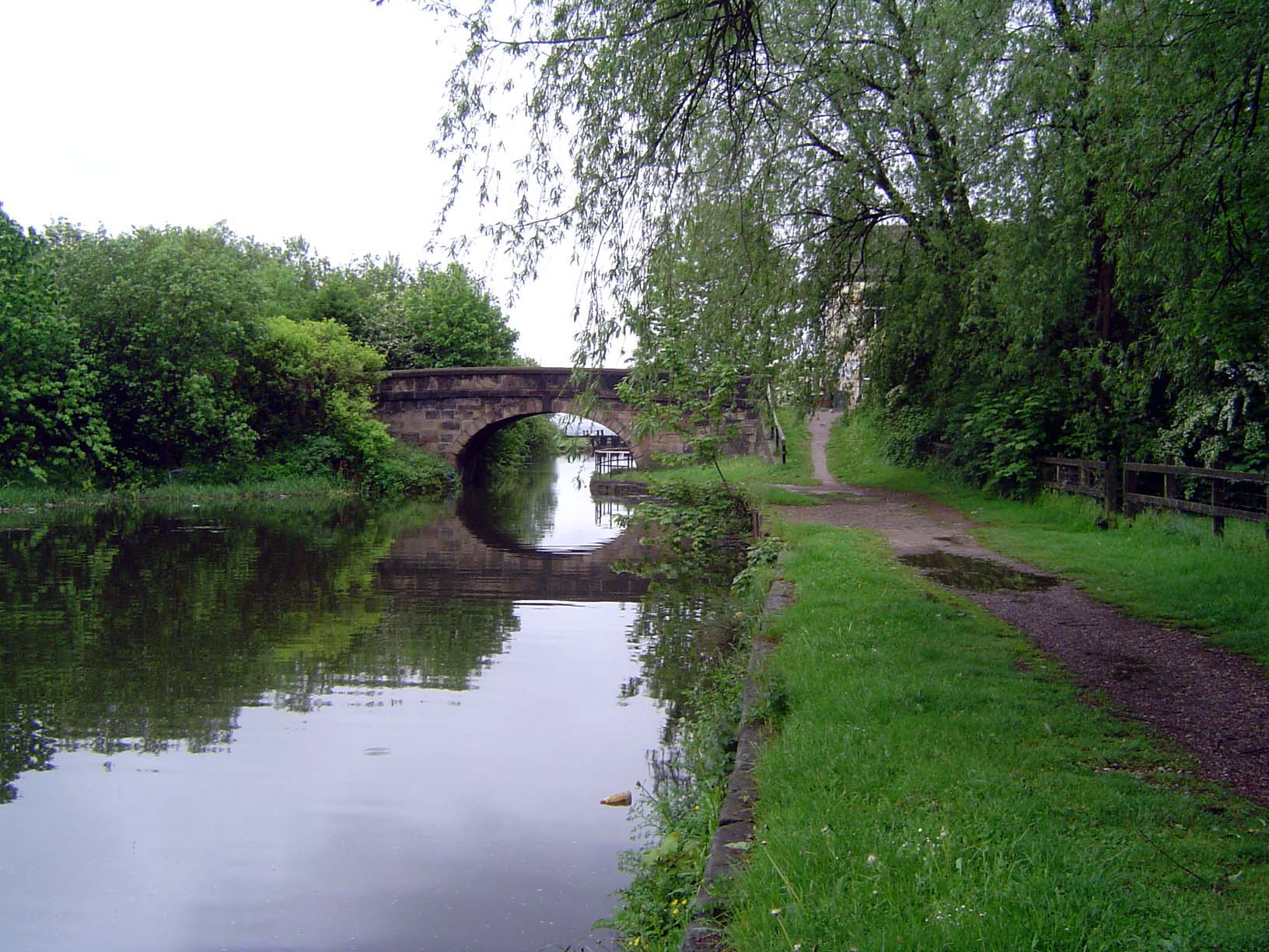 From time to time, an old bridge crosses the canal.