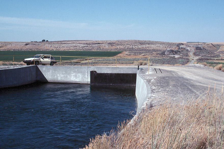 The east branch enters a siphon, shown here, with the far end visible in the background. The fine rental car helps date the picture.