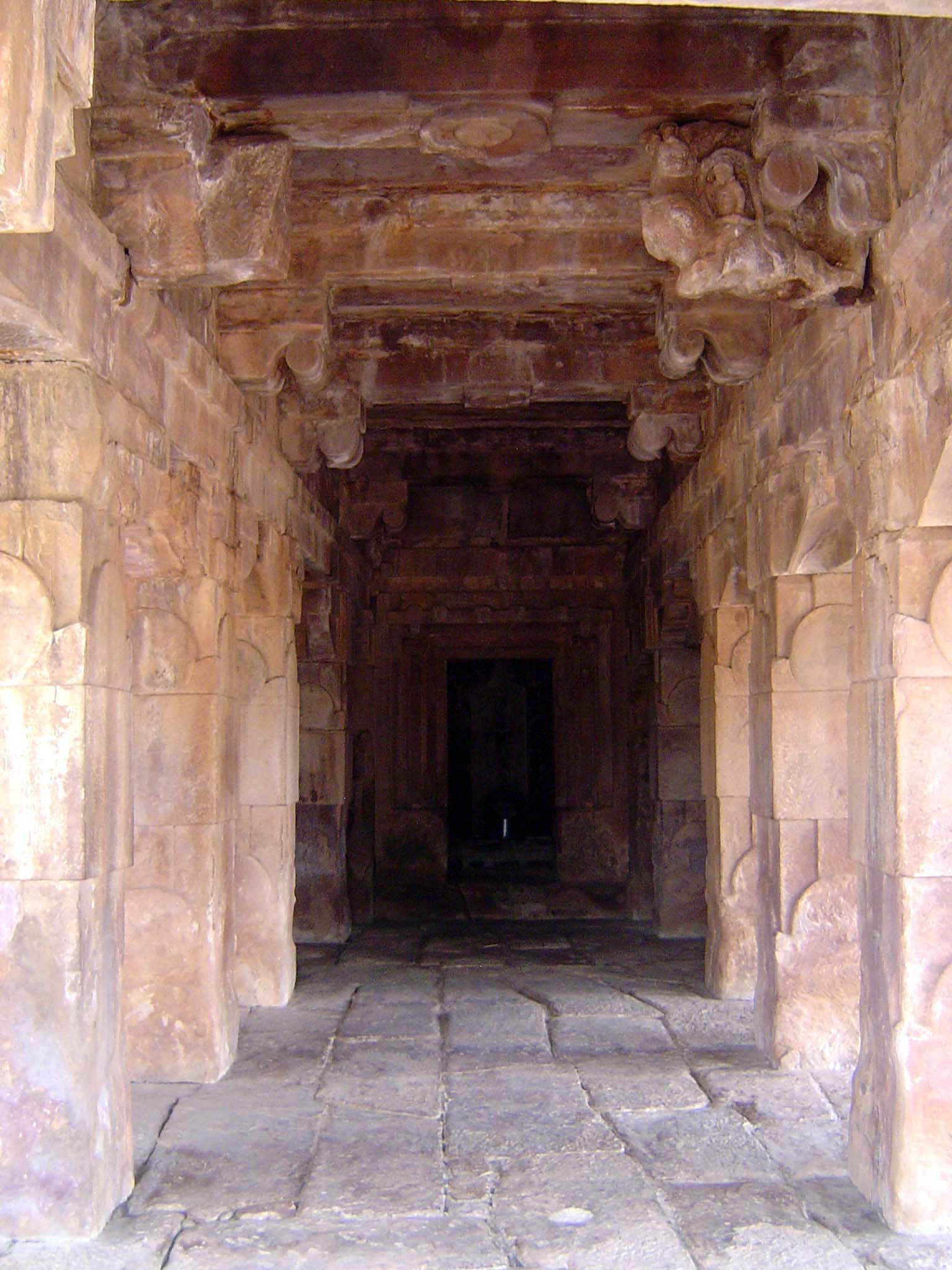 The interior is very simple, but in the dark shrine, the polished granite lingam reflects light.