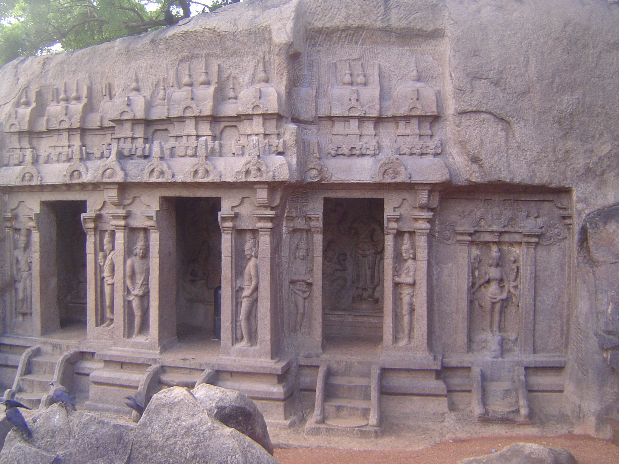 The Trimurti "Three Forms" Cave Temple is unusual because it is one of only a few finished monuments. It's also unusual for lacking a mandap