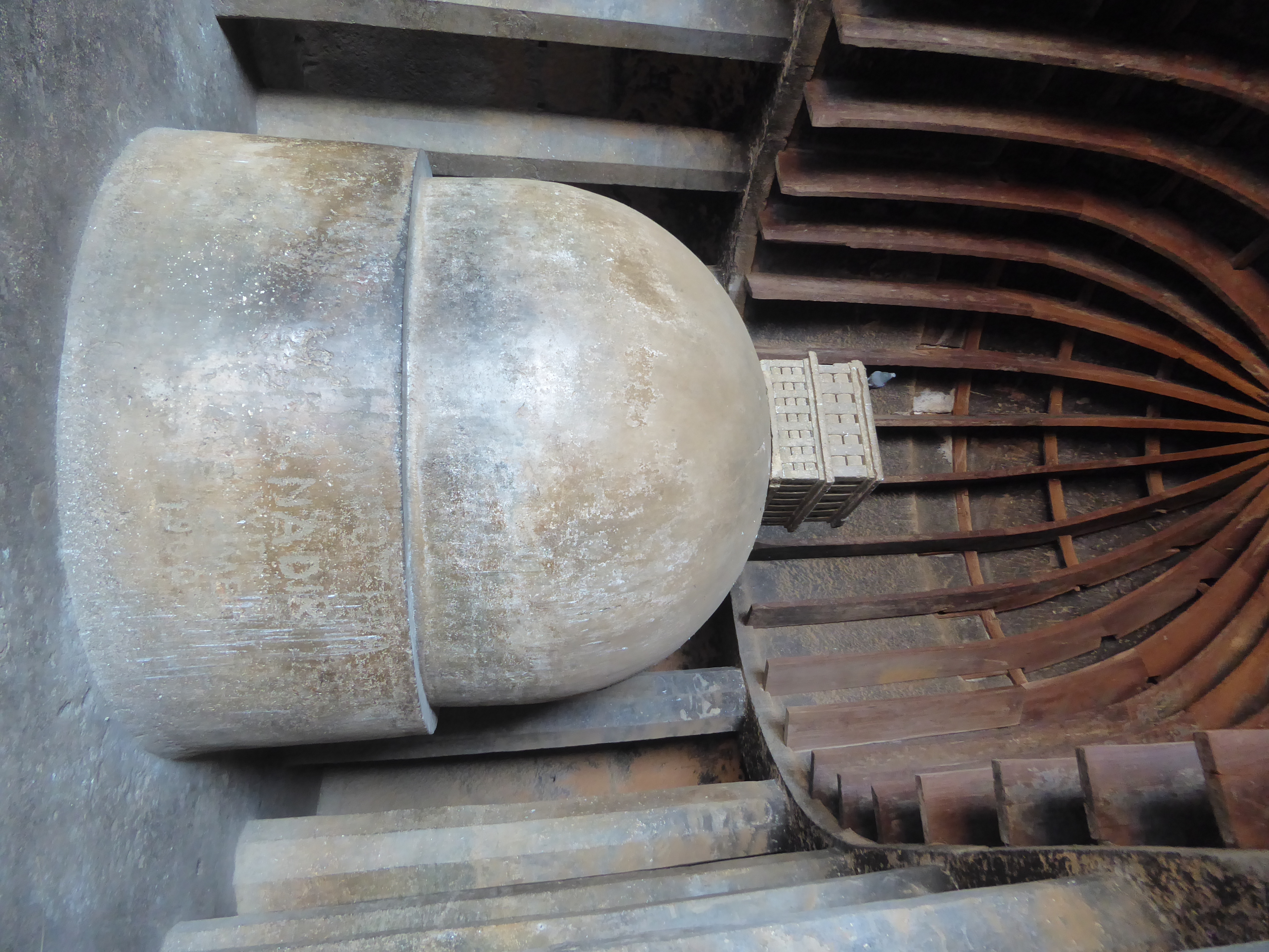 At the head of the cave there's a dagoba consisting of a cylinder, a dome, and a relic box and a pigeon. It's hard not looking instead at th