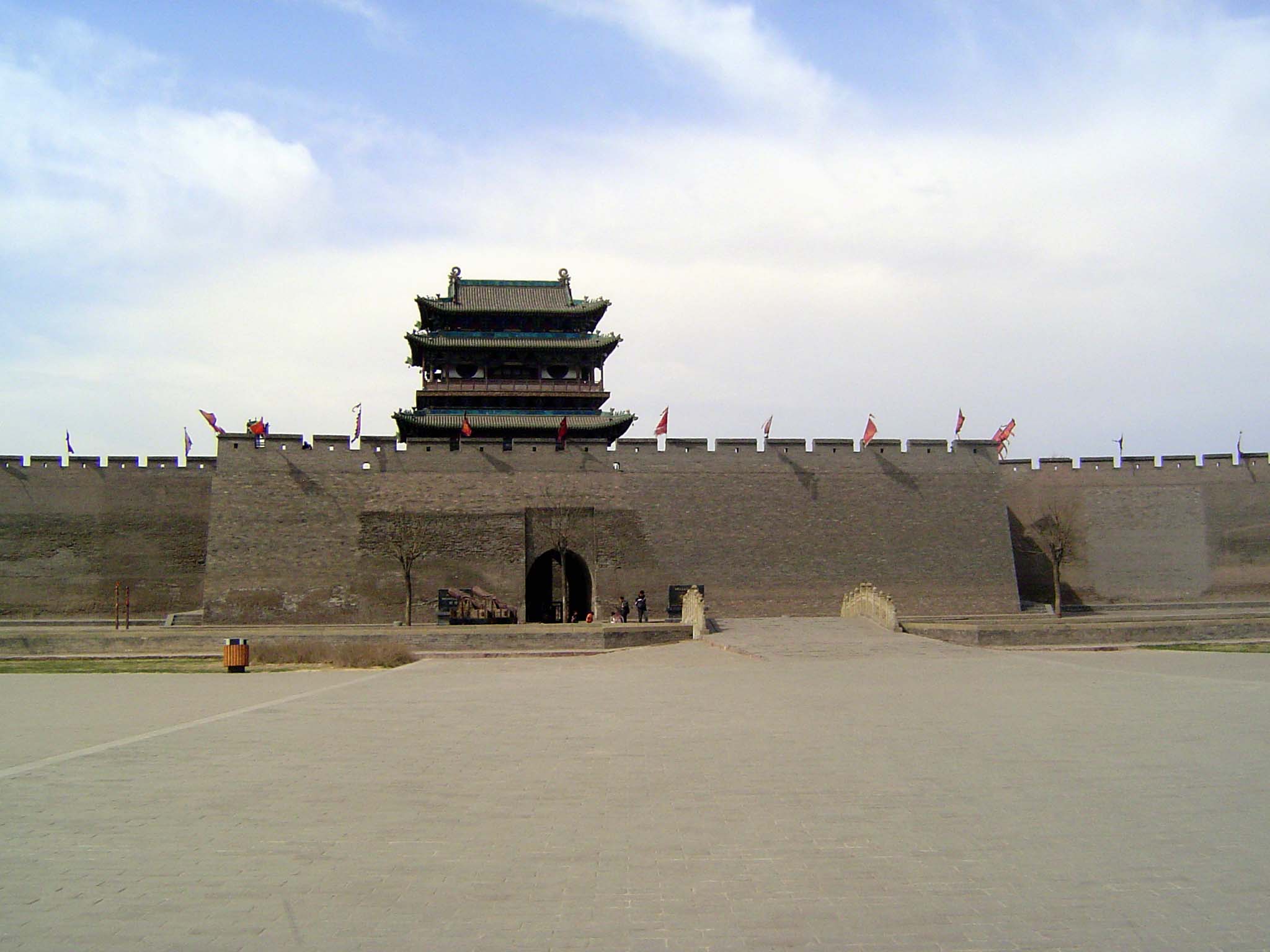 Before we go in, we'll do a bit of a circuit, here with the southern or Ying Xun Gate, built in 1703. The immense modern plaza is yet anothe