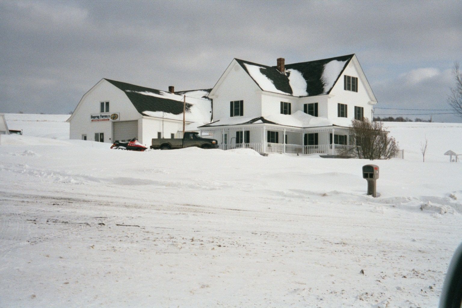 Rivers in snow, roads in snow: time for an iconic house in the snow. That's a potato barn out back: storage for a lot more than you can eat