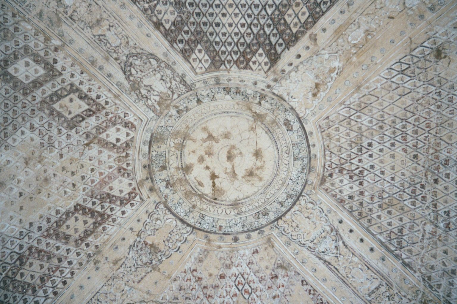 The ceiling vault is decorated with hundreds of Buddha images around the lotus pool of creation.