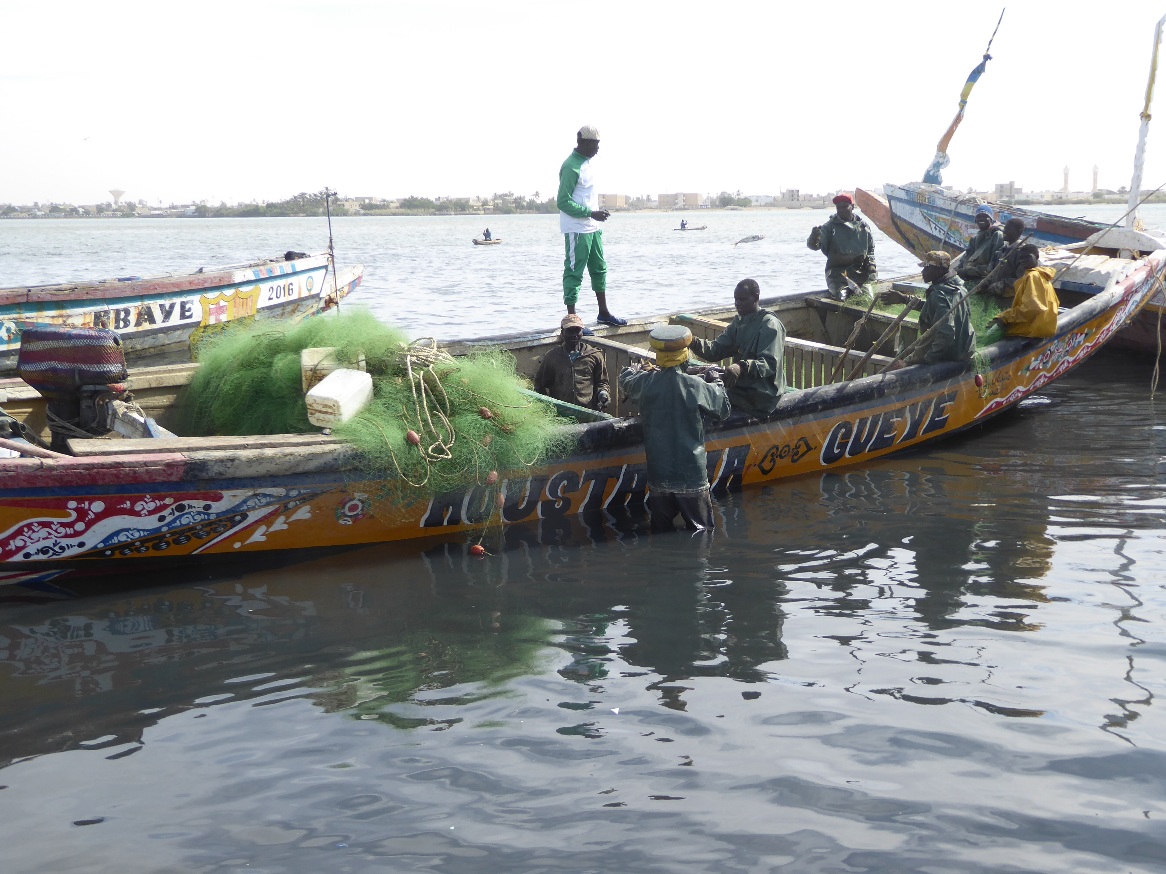 It's fishing season, and boats are arriving on the calm inside water of the Petit Bras.