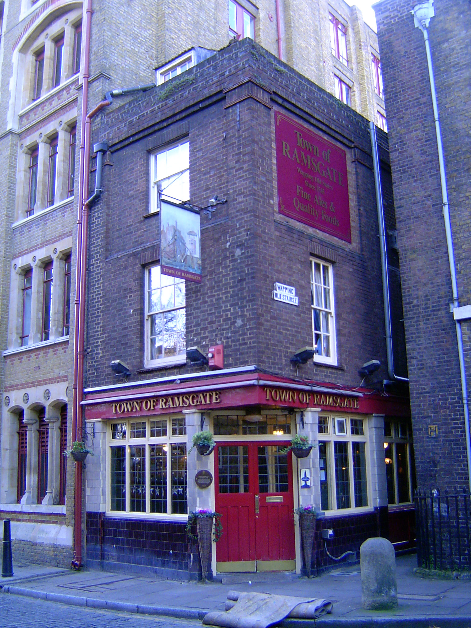 Another alley leads to the river. The black and white street sign reads Wapping Old Street.
