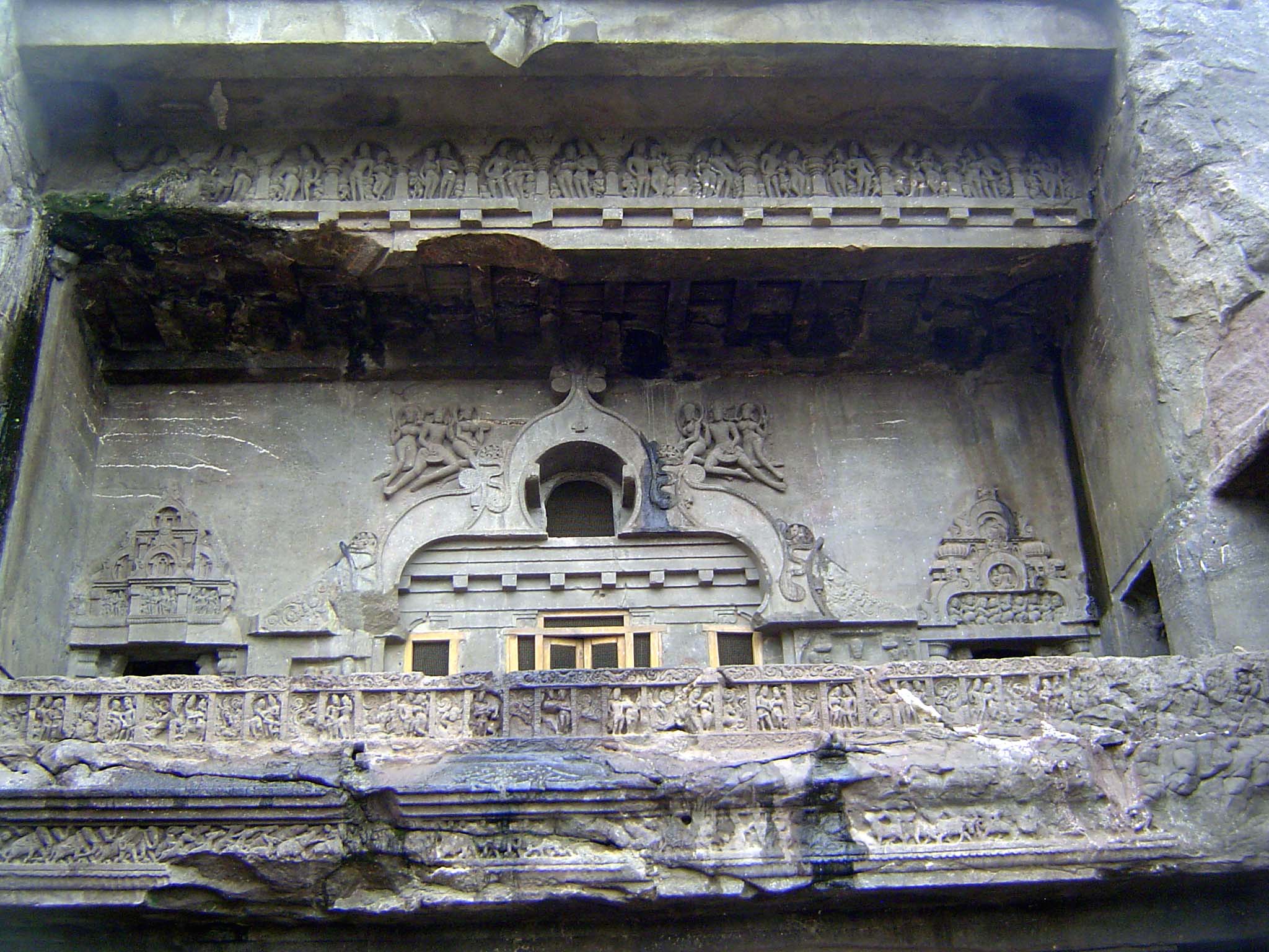 The upper level has flying figures around a window that shines into the room behind.