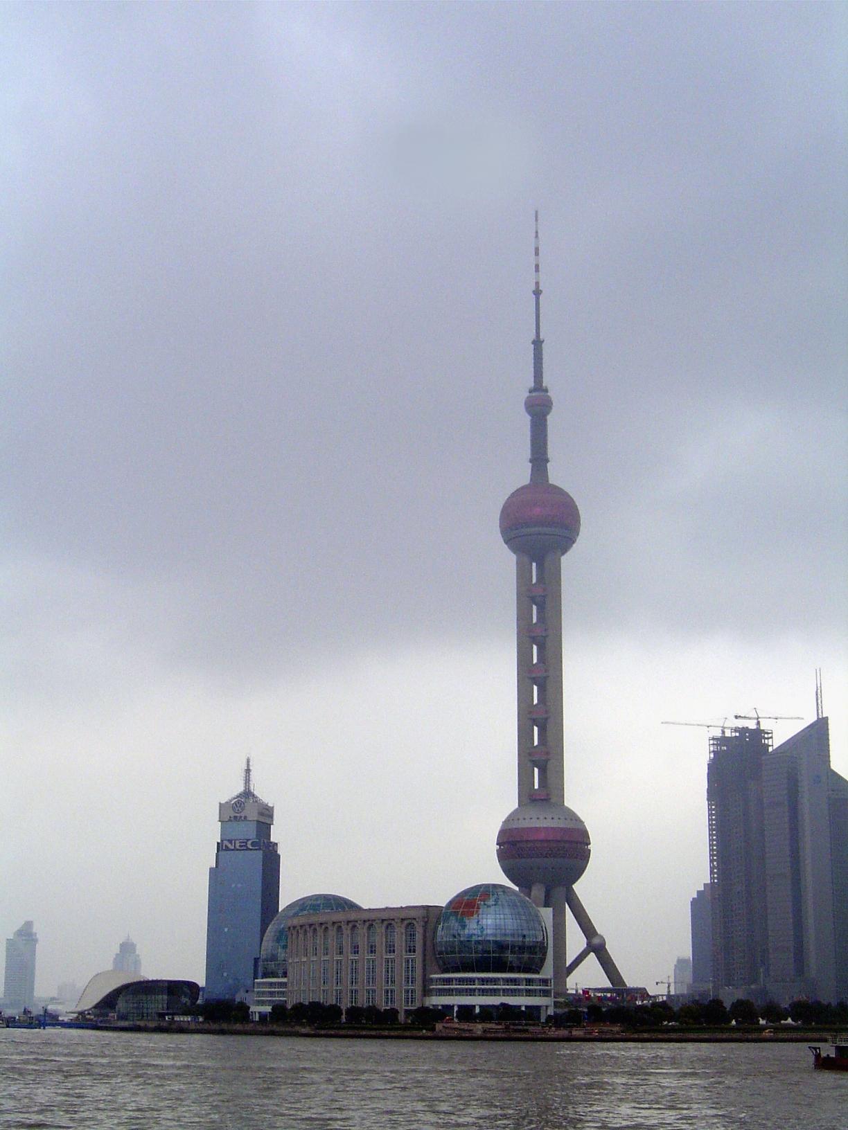 Across the river is Pudong, an immense area, roughly triangular with one side the Huangpu, another side the ocean, and the third side a line
