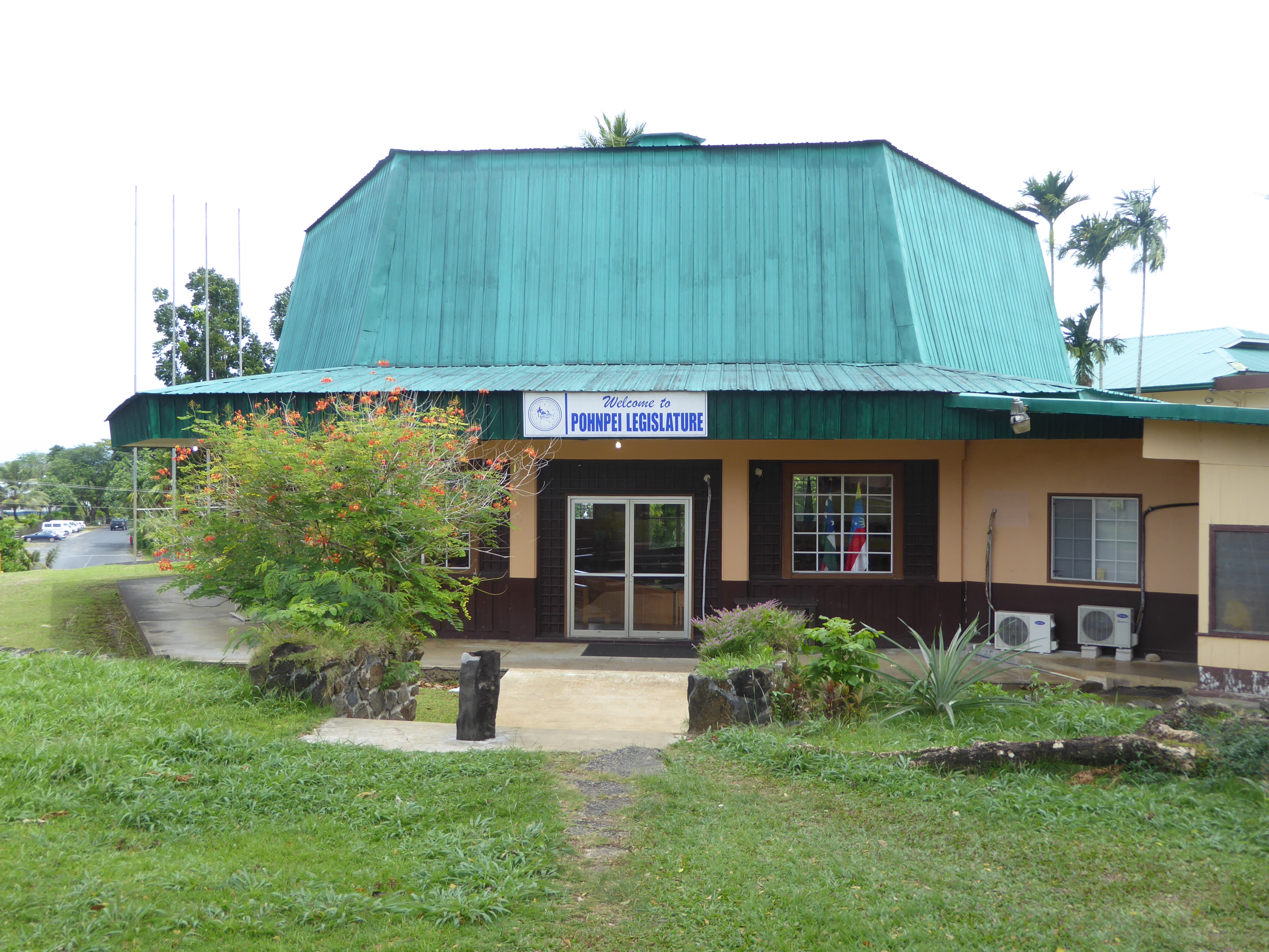The Pohnpei Legislature meets here. Who do you think built the place? For the answer, walk over to the group of flagpoles.