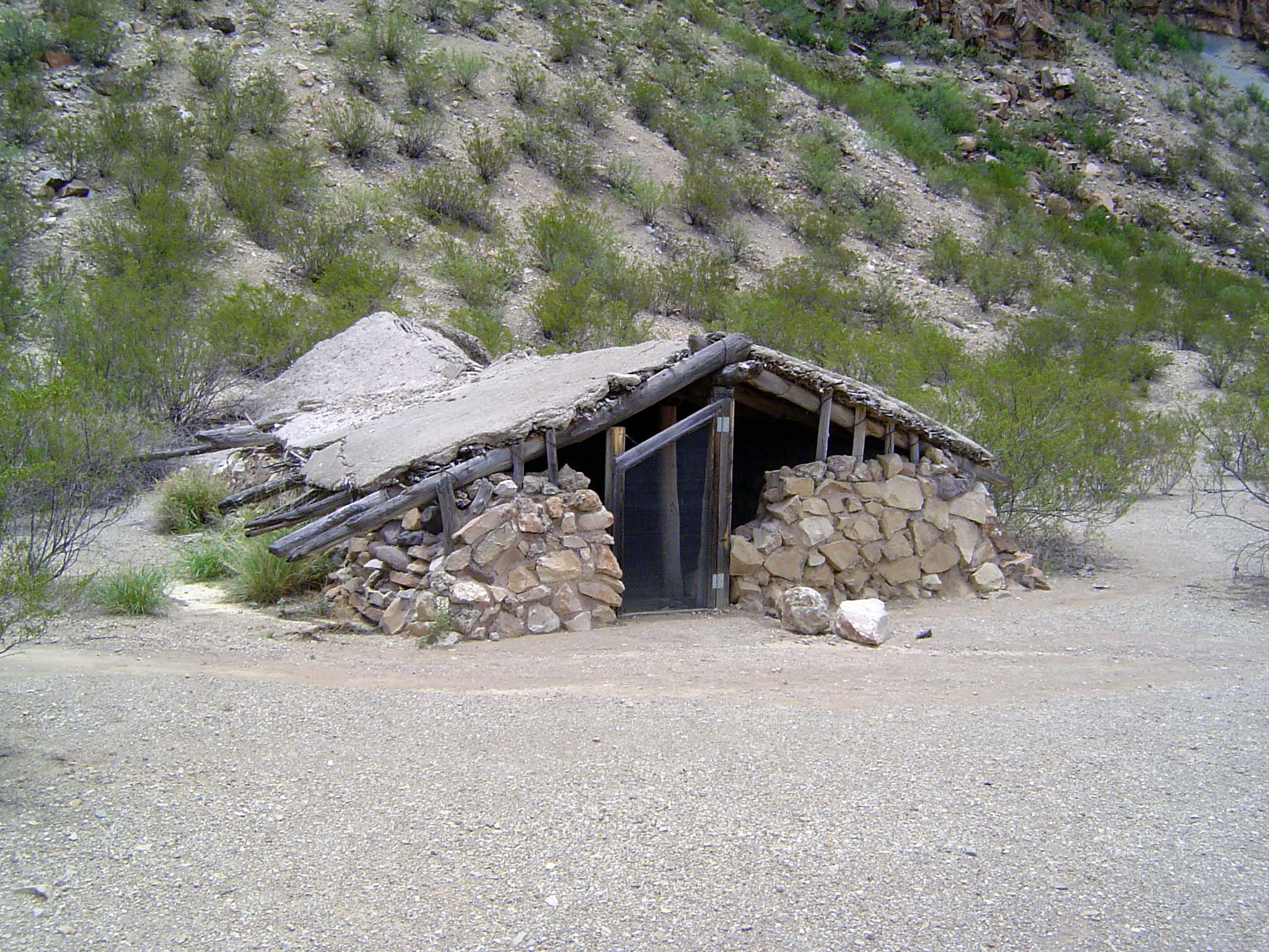 An abandoned house, half-buried for insulation.