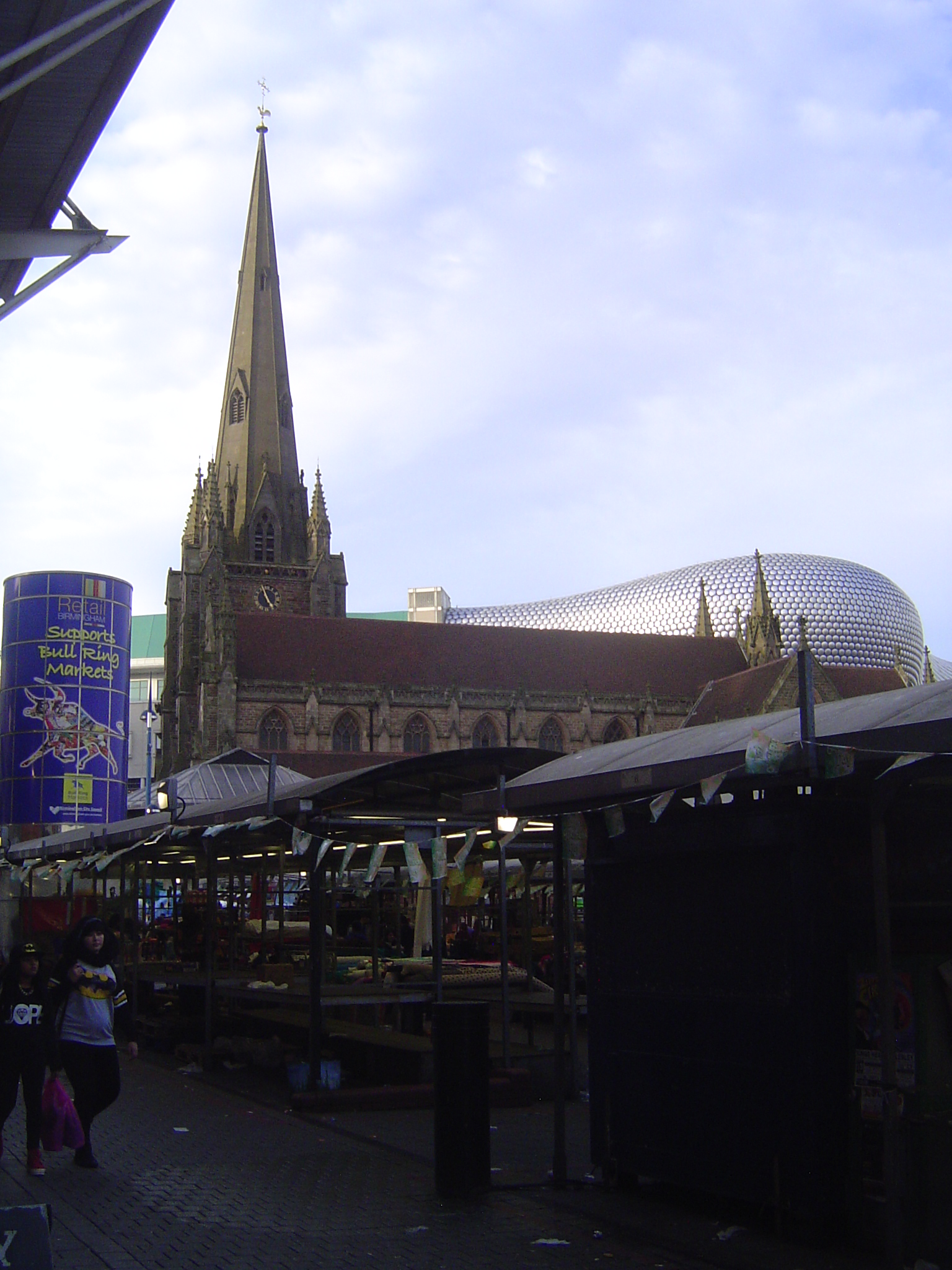 What grabs your eye? Not the open-air market, plunged in shadow. Not the city's old church, St. Martin in the Bull Ring. Inevitably, it's "t