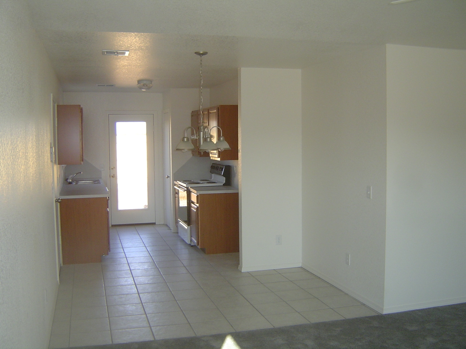 We're standing in the living room and looking toward the kitchen and dining. The door on the left is to the one-car garage. To the right are