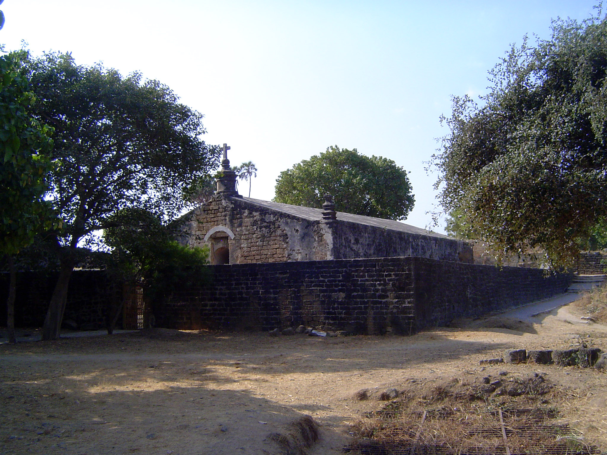 The cross suggests that this was a church, although the lack of windows suggests otherwise. It was, in fact, a powder magazine, and its wall
