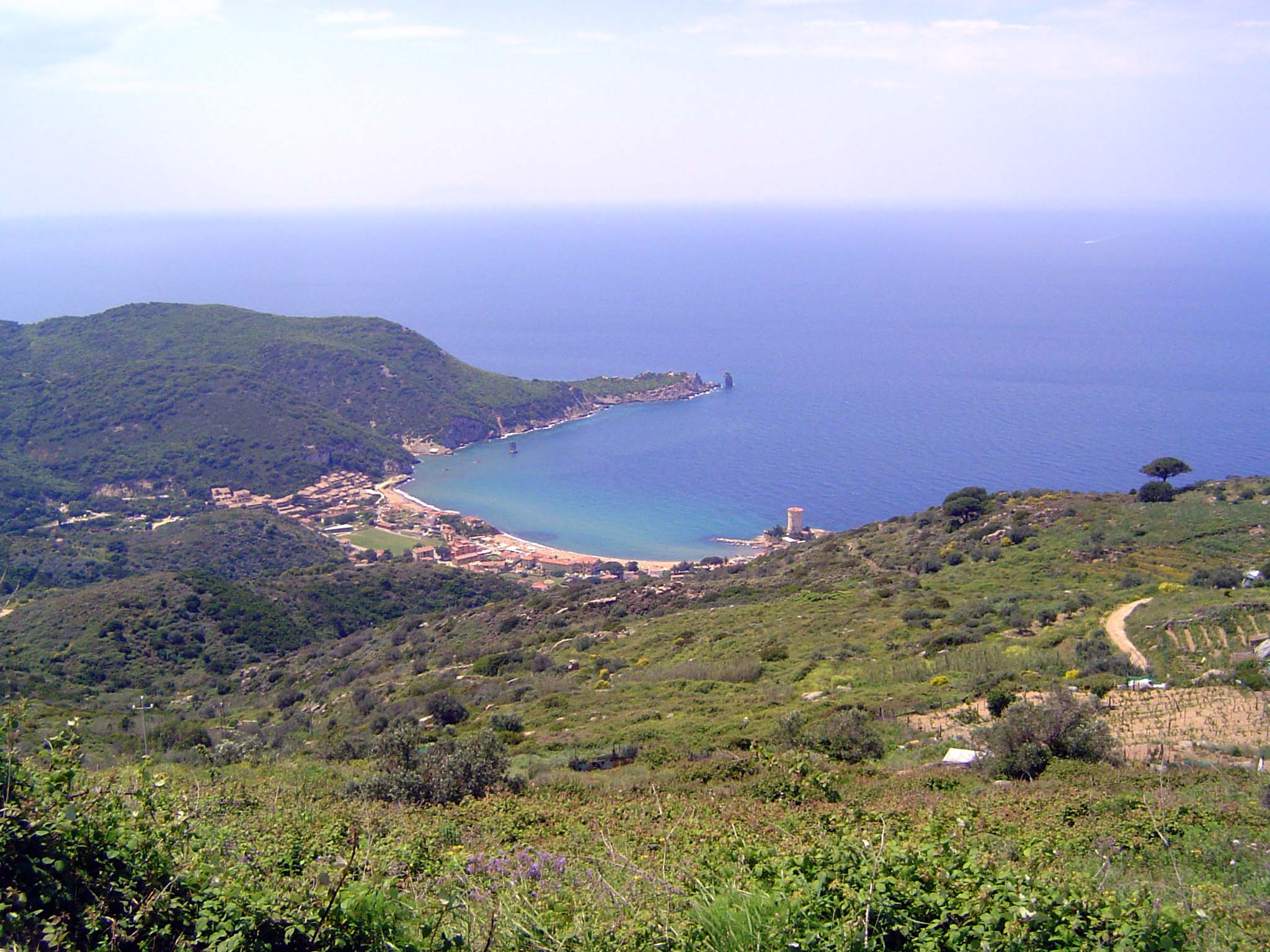 The view from Castello down to the island's west coast, facing the infinite Mediterranean. This is the island's best beach, which is why mos