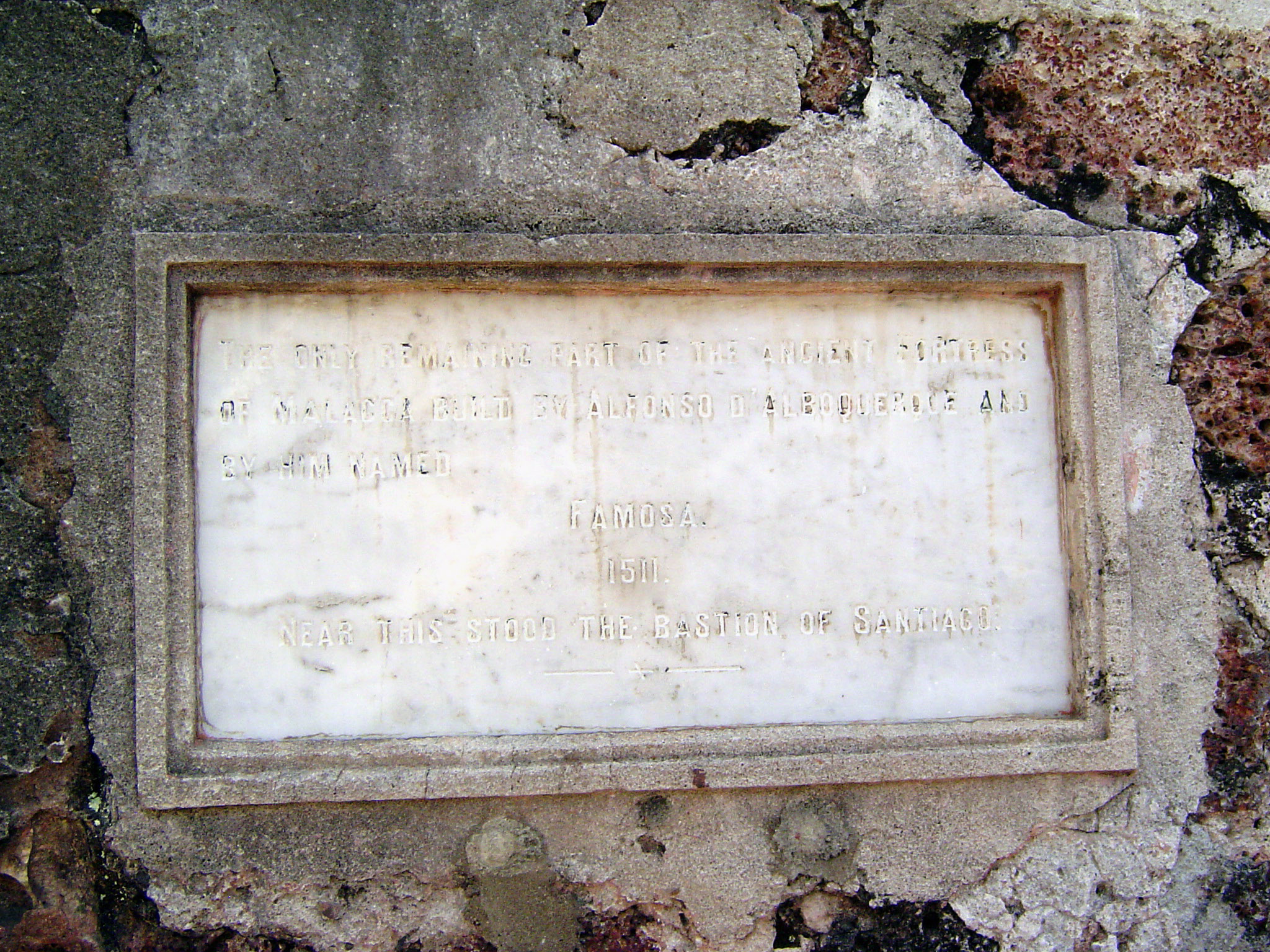 Busy destroying the wall, the British caught themselves just in time, saved this gate, and posted this plaque: "The only remaining part of t