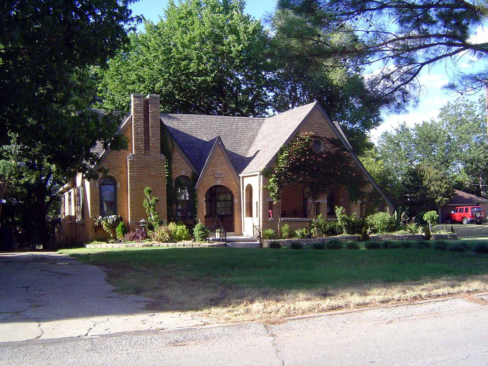 Here, at 2005 NW 22nd, is a brick home from 1926. The half-timbering is gone, but we still have the oversteepened gables that suggest Thomas
