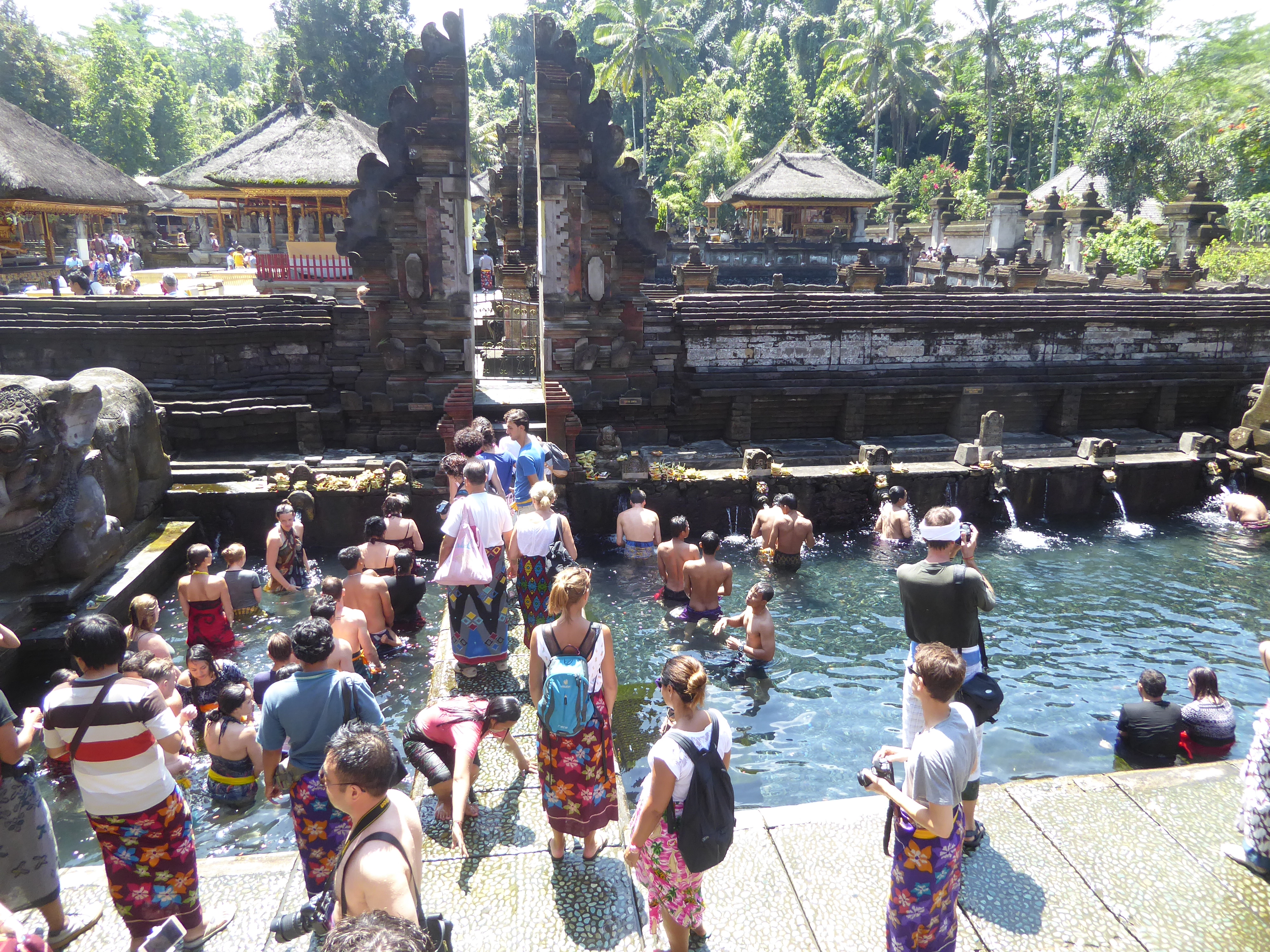 Tourist beaten? Beyond the split gate or candi bentar is the famous Tirtha Empul, usually translated as "holy spring." Its water flows into