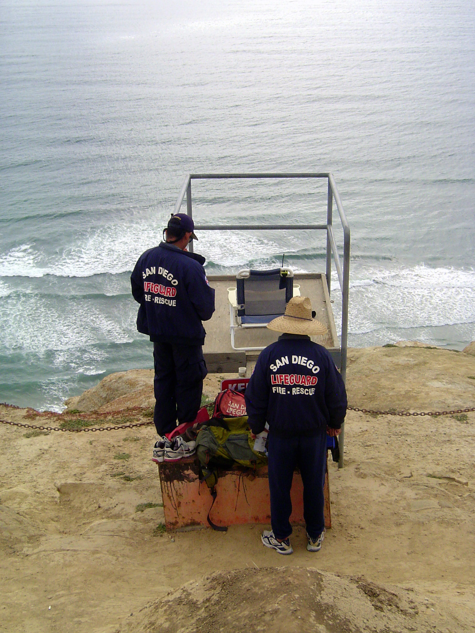 High above the water, lifeguards are in radio contact with guards on the beach below.