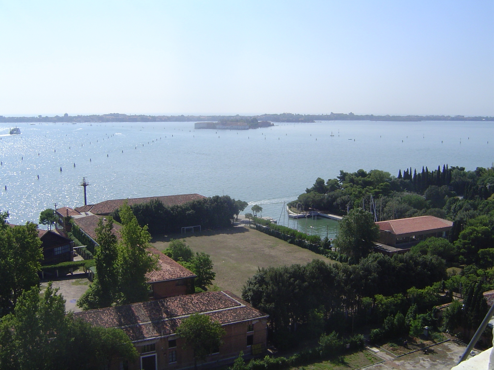 The Lido is across the lagoon; beyond lies the Adriatic. The piles indicate safe channels. In the foreground, of course, is a bit of the Iso