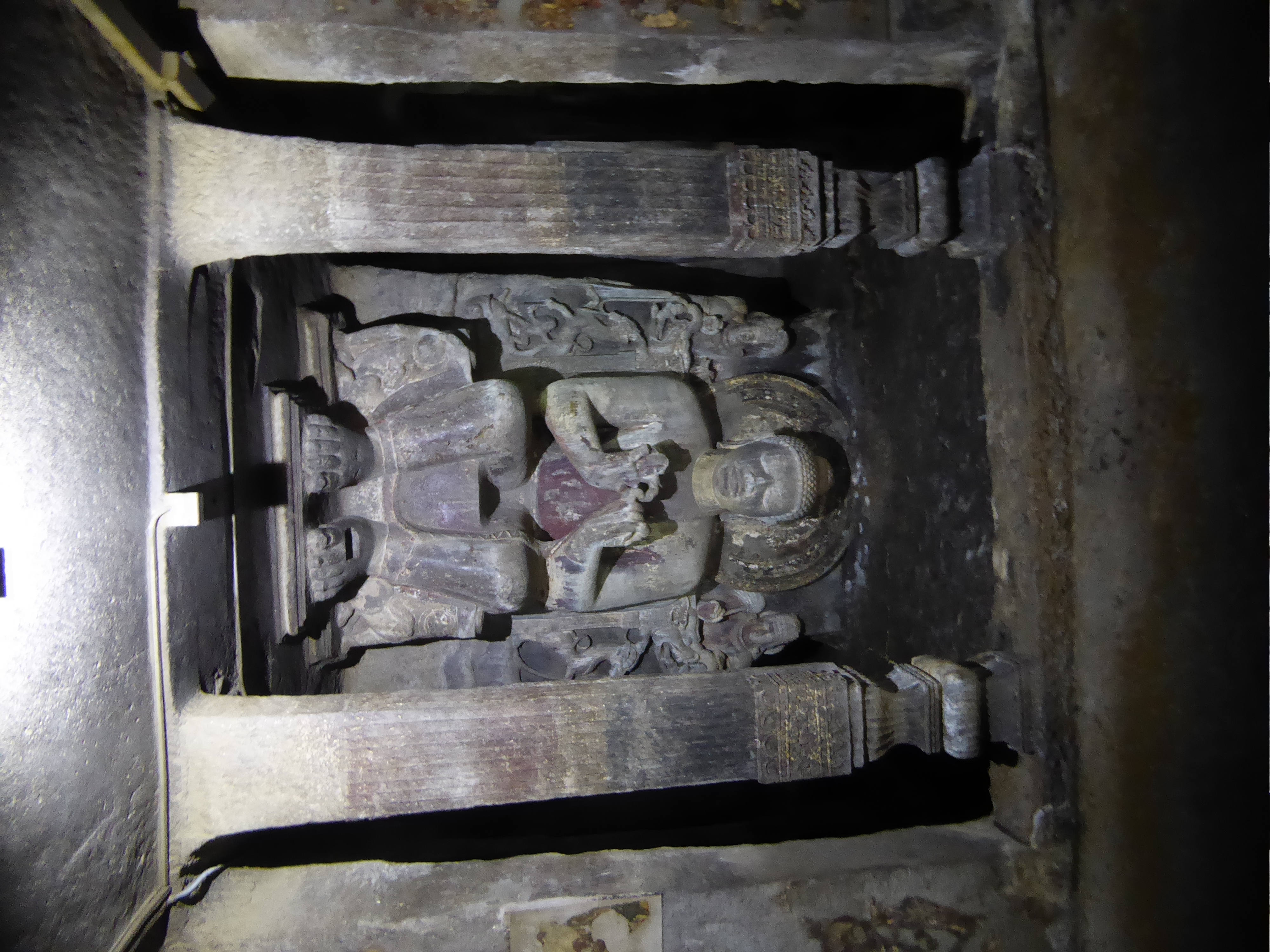 The shrine carries an image of the Buddha in the instructive dharmachakra or teaching mudra. There's also room behind him for monks to circl