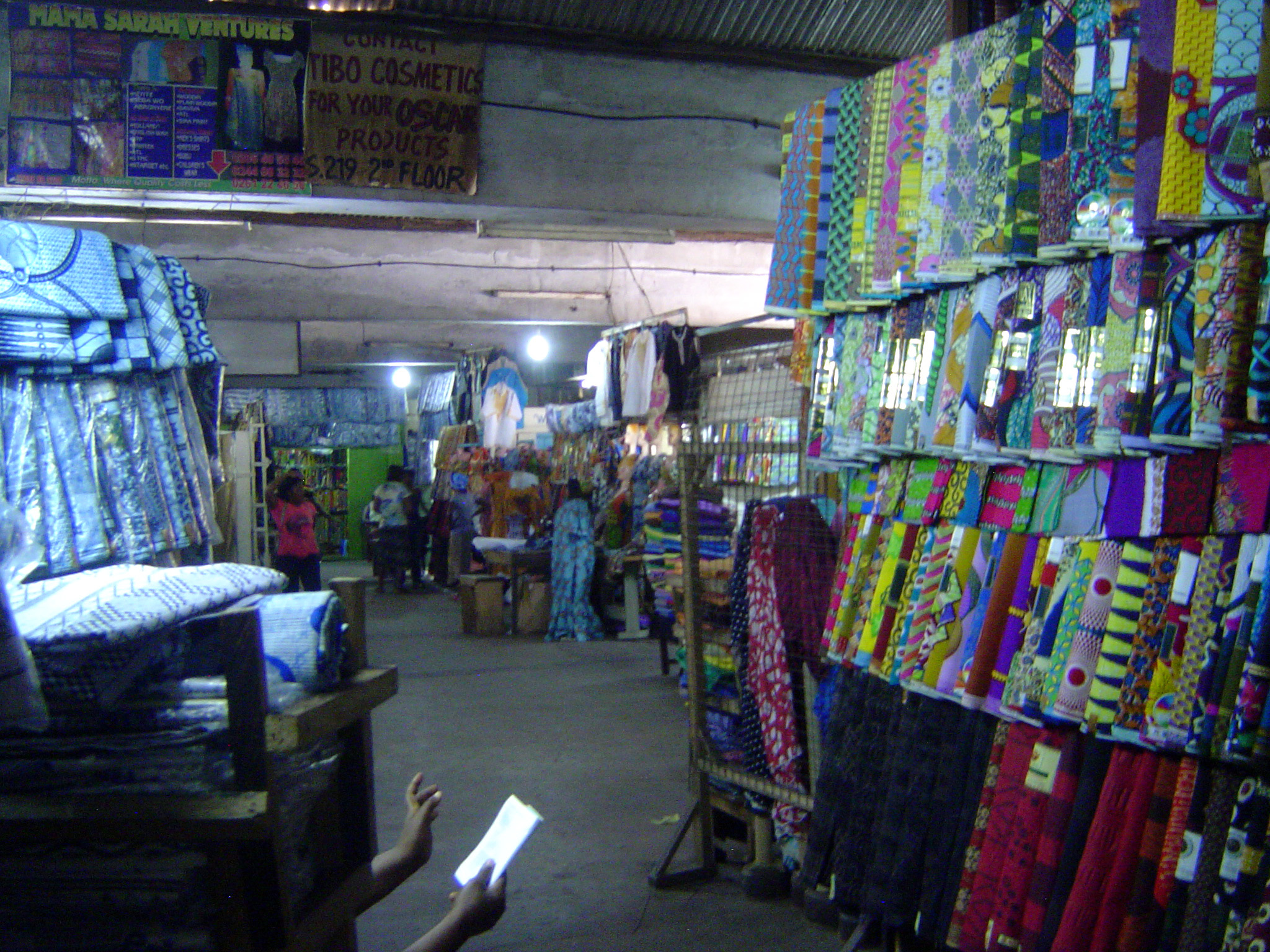 Upstairs, there's a collection of cloth stalls. It's hot as an oven in here.