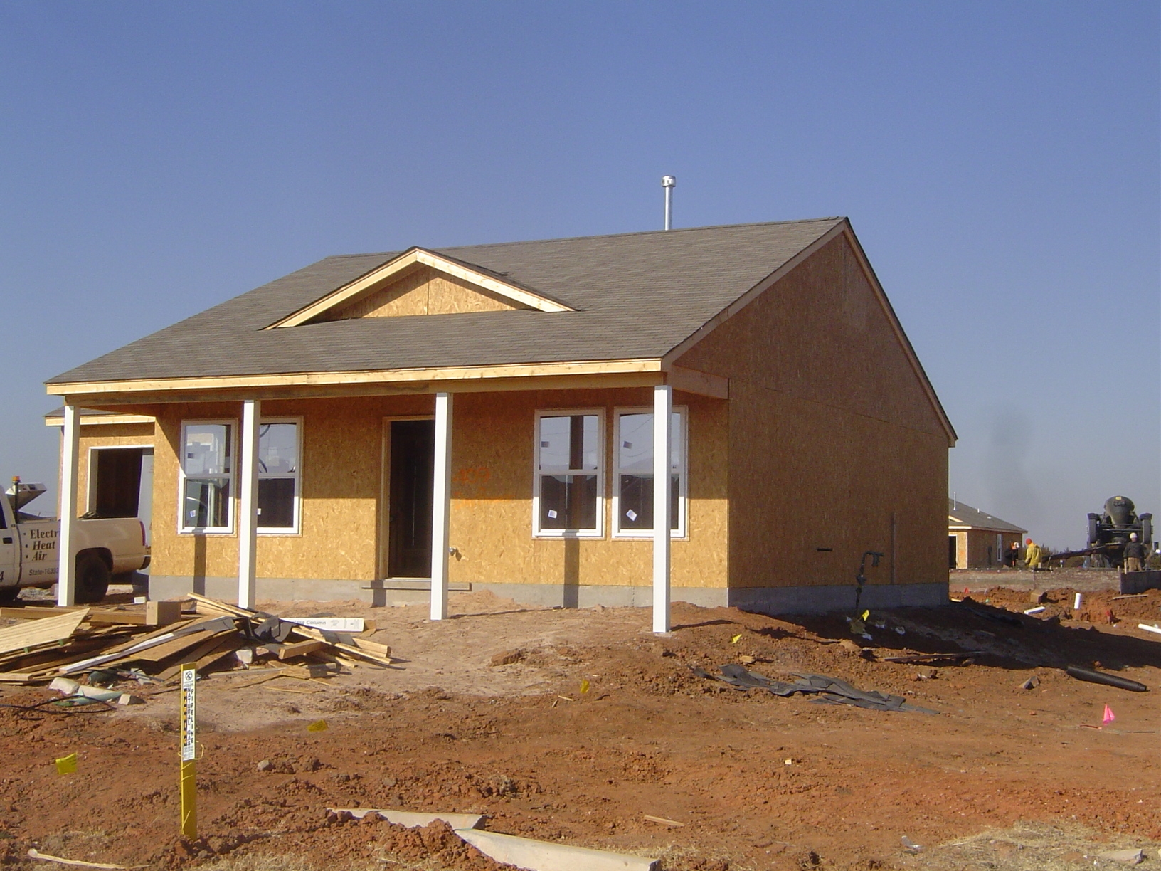 You can see here some of the underlying structure of the house, including the stem wall and the framing, with OSB or "oriented strand board"