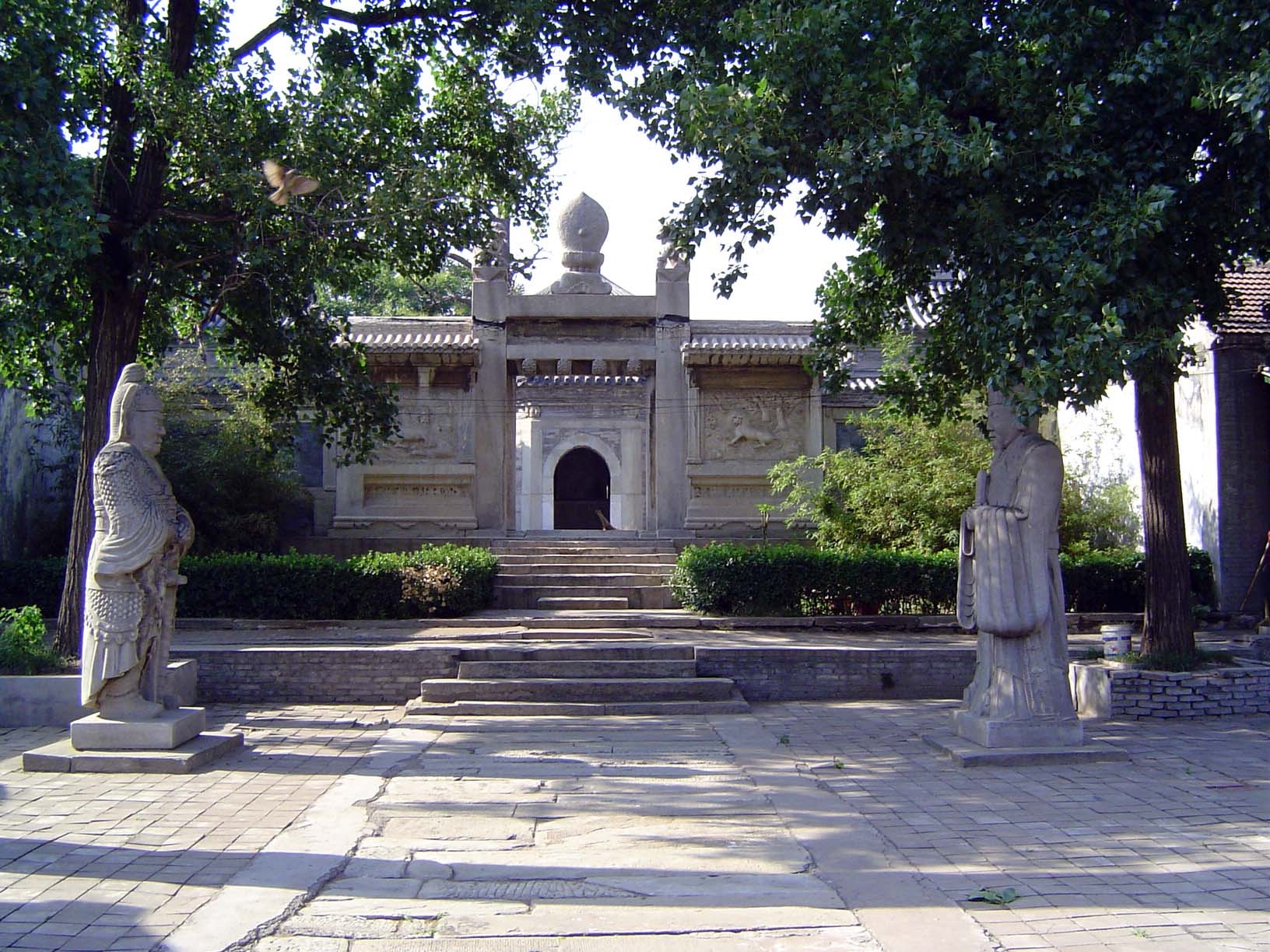 The path leads past a pair of statues of military and civil officers, much like those on the Sacred Way at the Ming tombs.