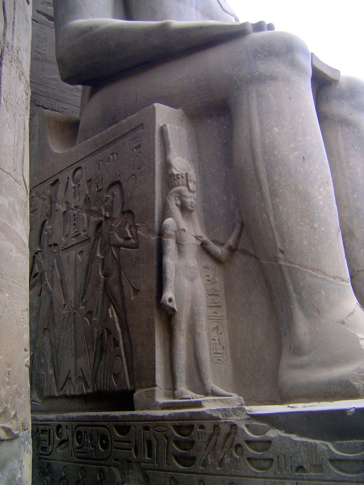 Lateral images of the king's wife and daughter don't even reach his knee; once again, the Nile gods are at the side.