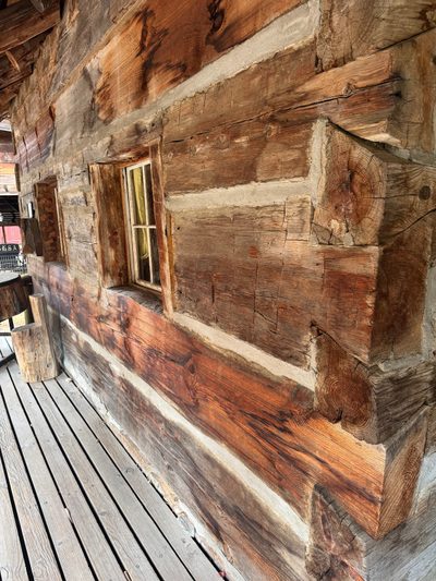 A sign explains that the structure was enclosed in a larger home built about 1900 and was only discovered when that larger home was demolish