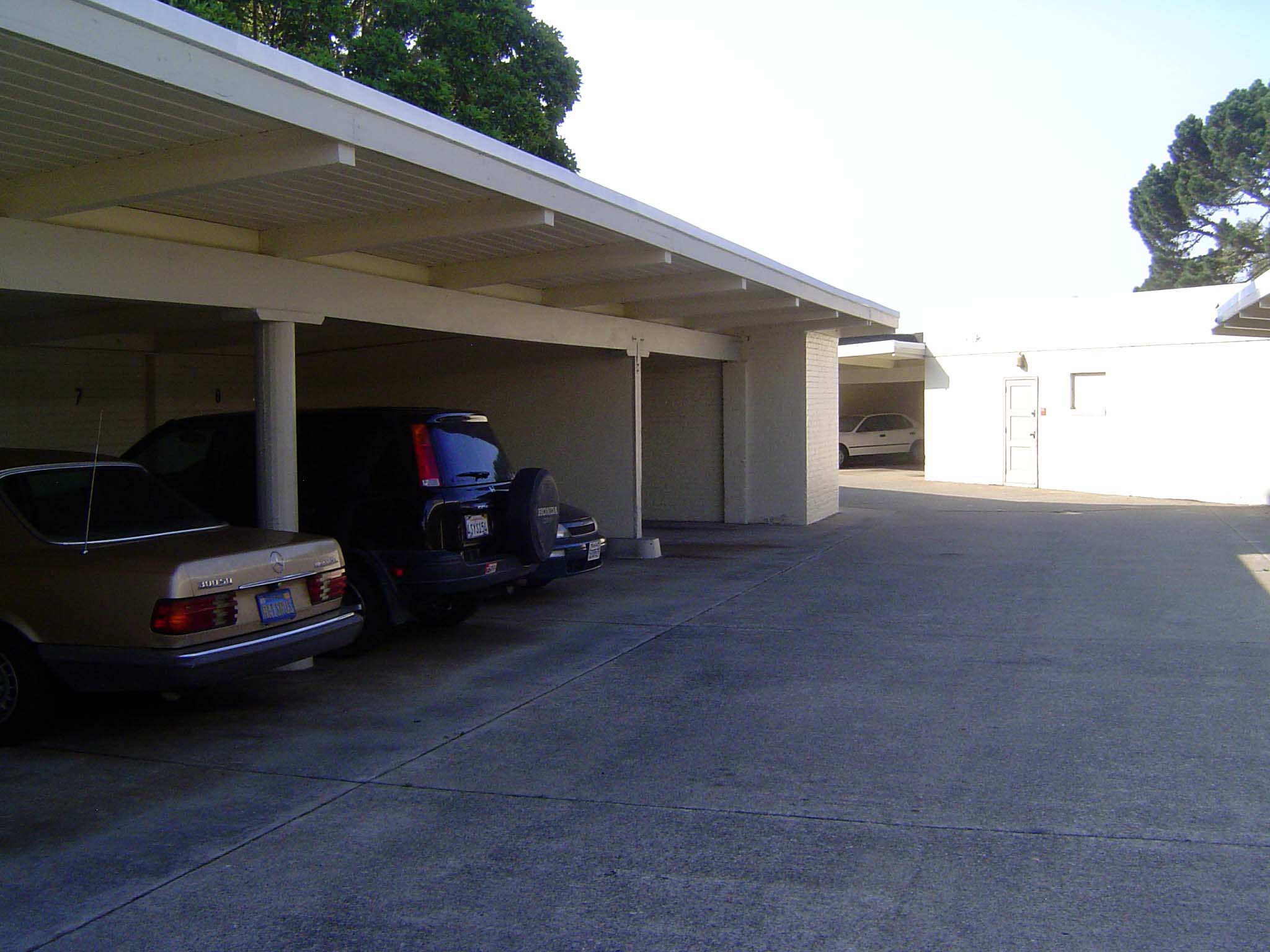 Every renter got a parking space in the carports. One resident got a new car every year. The boy's father thought it was a ridiculous waste