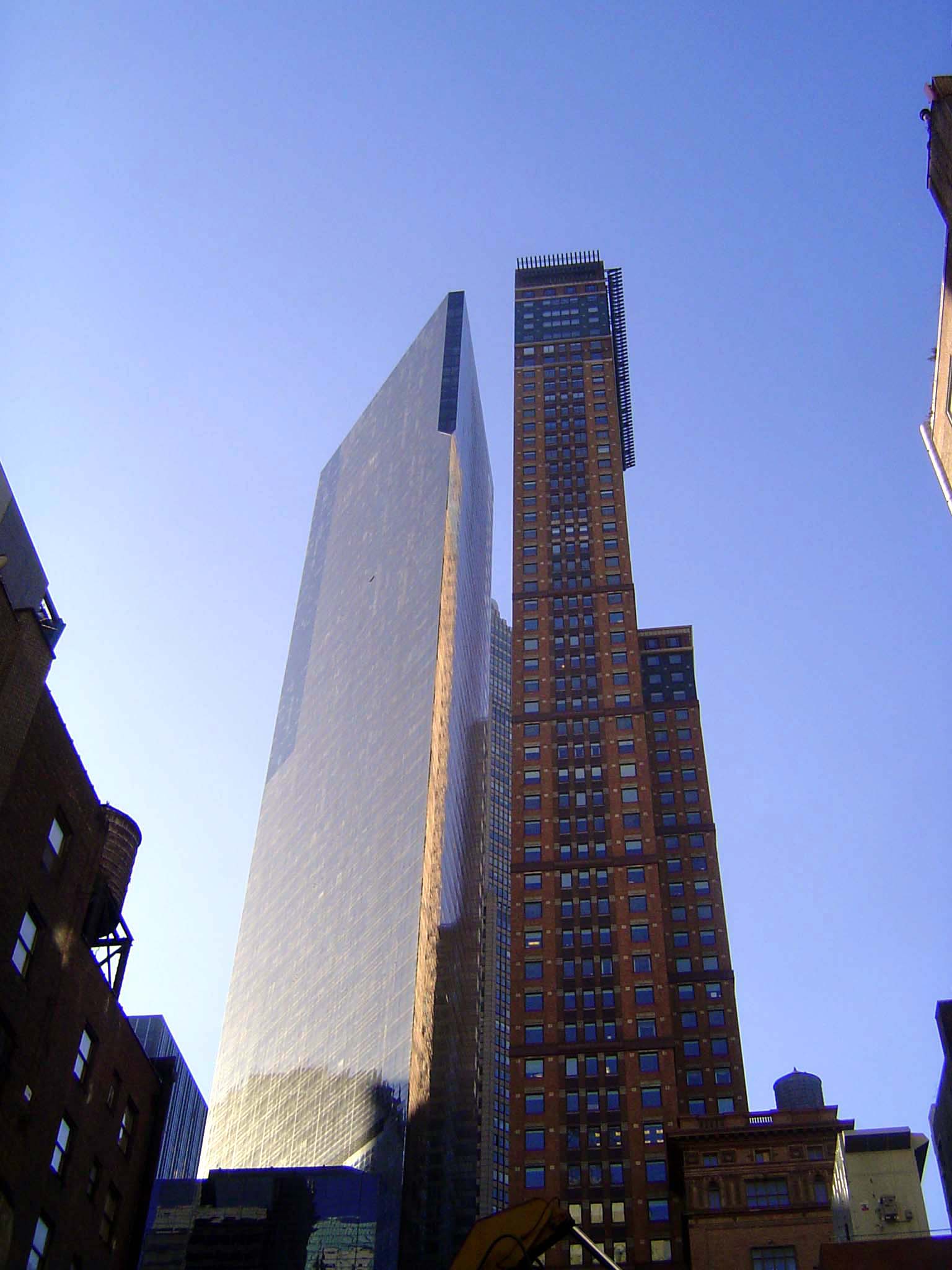 Shoulder to shoulder, the triangular Metropolitan Tower on the left stands next to Carnegie Towers, a "highrise Medici" office building by C