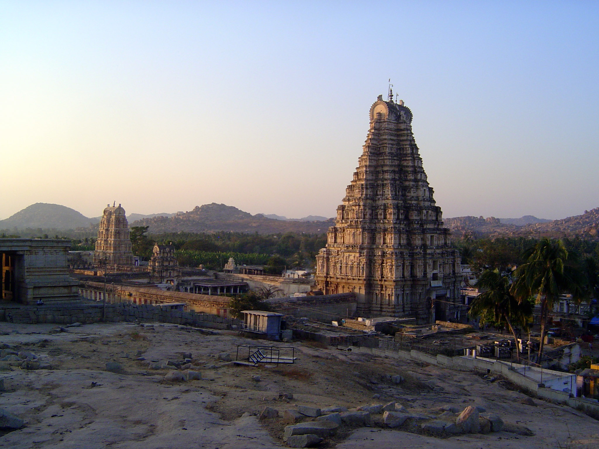 A fuller view of the temple including the second gopura and the north one. The building at the left once had a stepped roof, suggesting inco