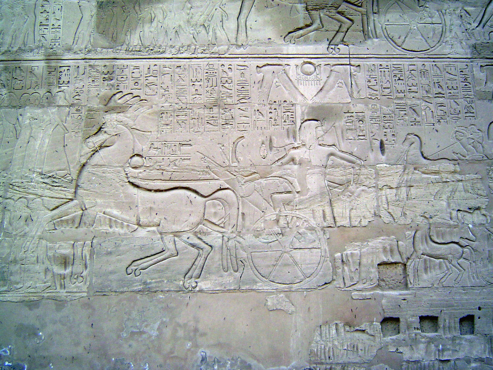 On the same wall, Sety I, conqueror of the Hittites, smiles for posterity while driving prisoners back to Thebes as a gift to Amun-Ra. An in