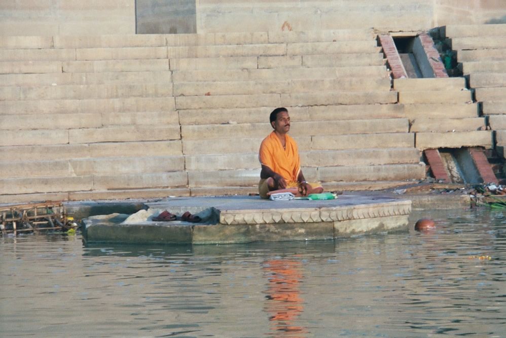 Morning prayers at one of the many ghats or steps that line the river's edge. The flotsam is disgusting to a few, trivial to the many.