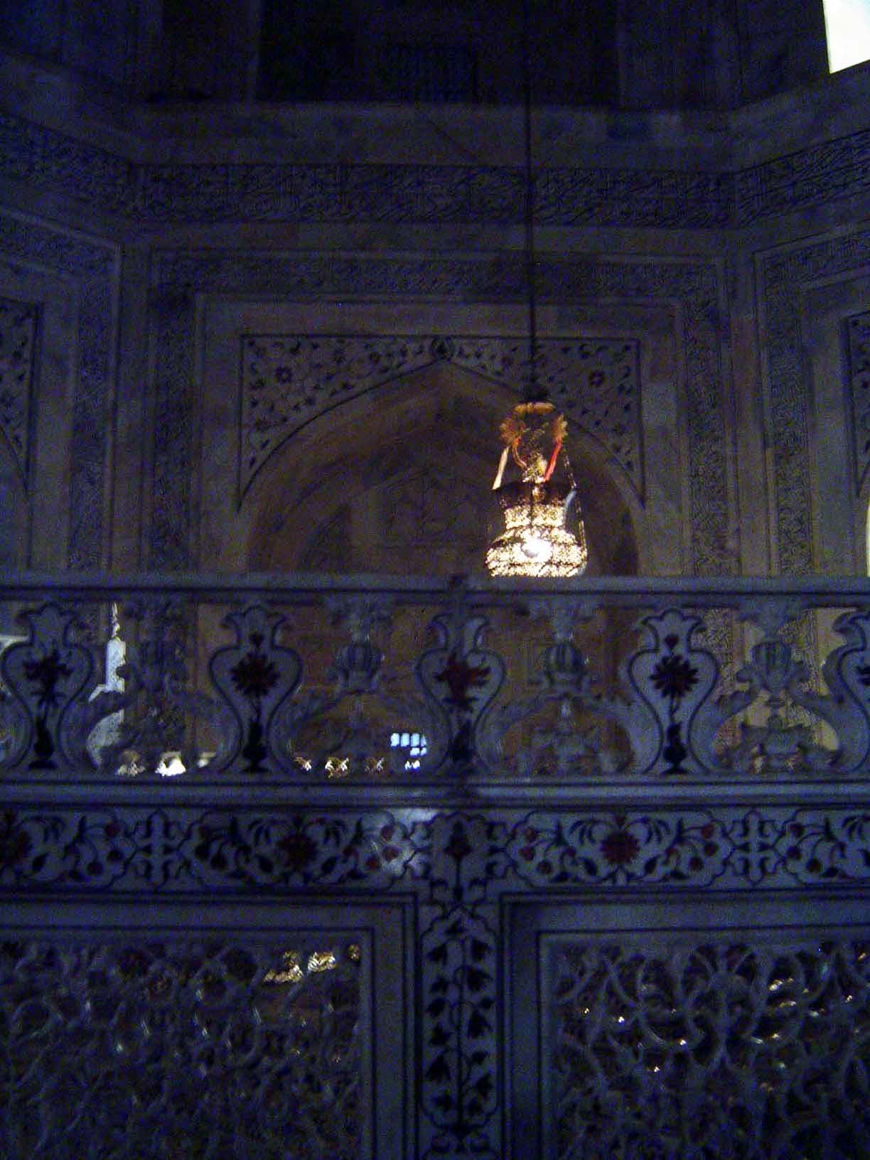 The cenotaph is screened by marble trellis-work jalis. The hanging lamp was ordered from Cairo by Curzon, who as viceroy took a serious inte
