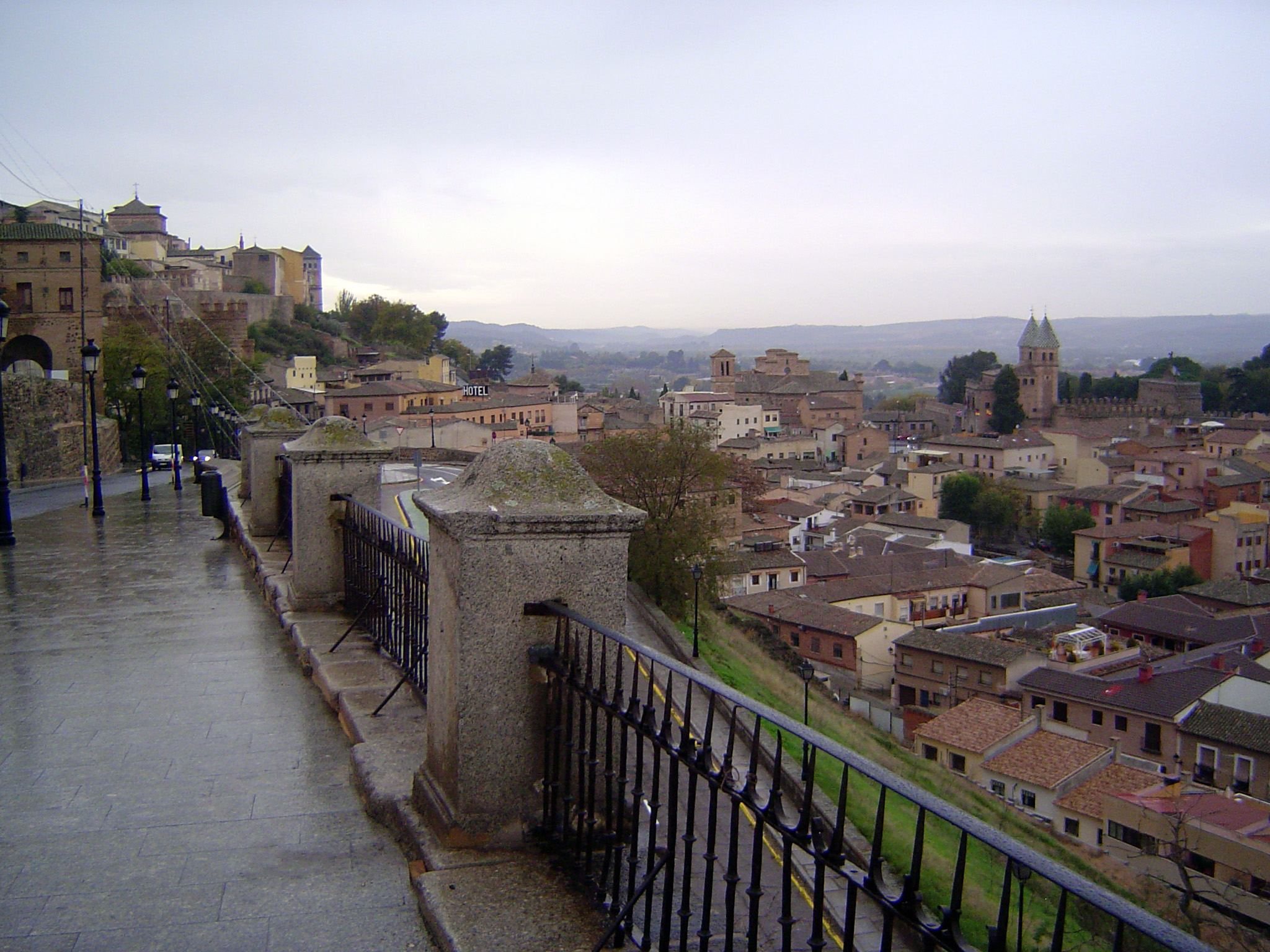 The crenelations of the same gateway can be seen in the middle distance on the left. The slope continues down to a second gate, marked by ti