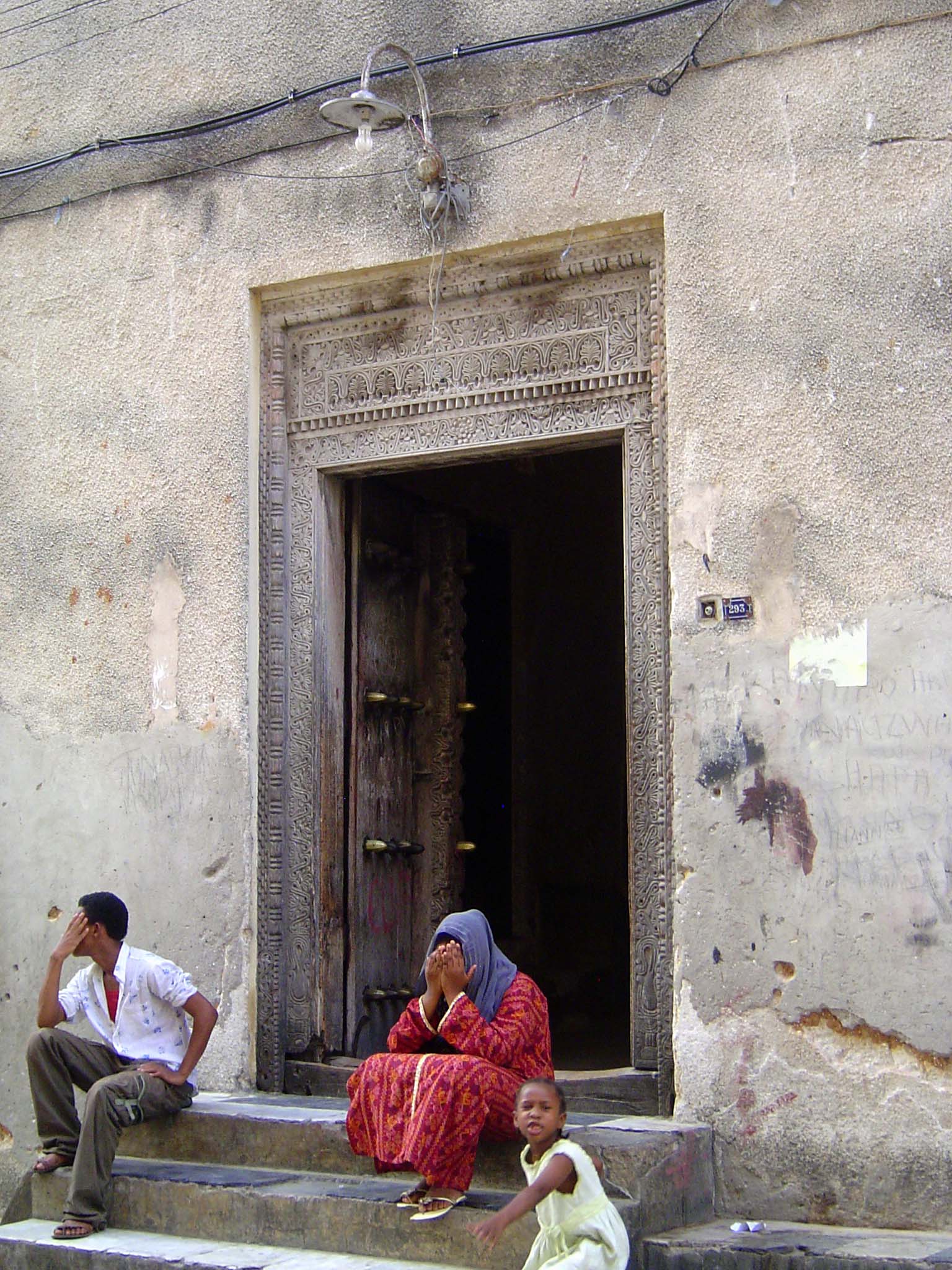 Tradition hasn't been entirely washed away by the tourist tide. Here, a fine Omani door with residents tired of cameras.