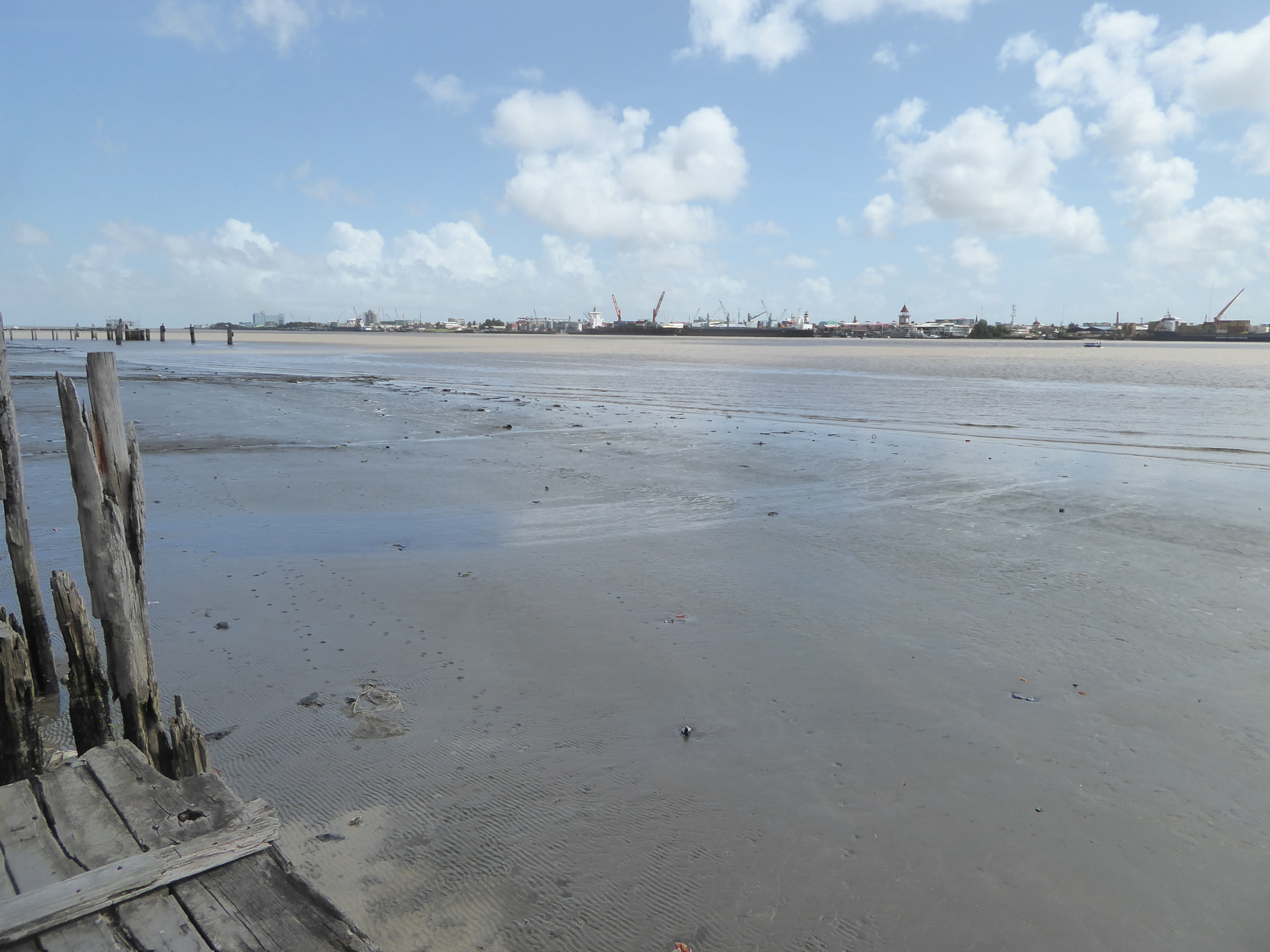 The blue hulk of the Marriott marks the river's mouth. The pyramidal tower at the right center is the Stabroek Market, which is the location