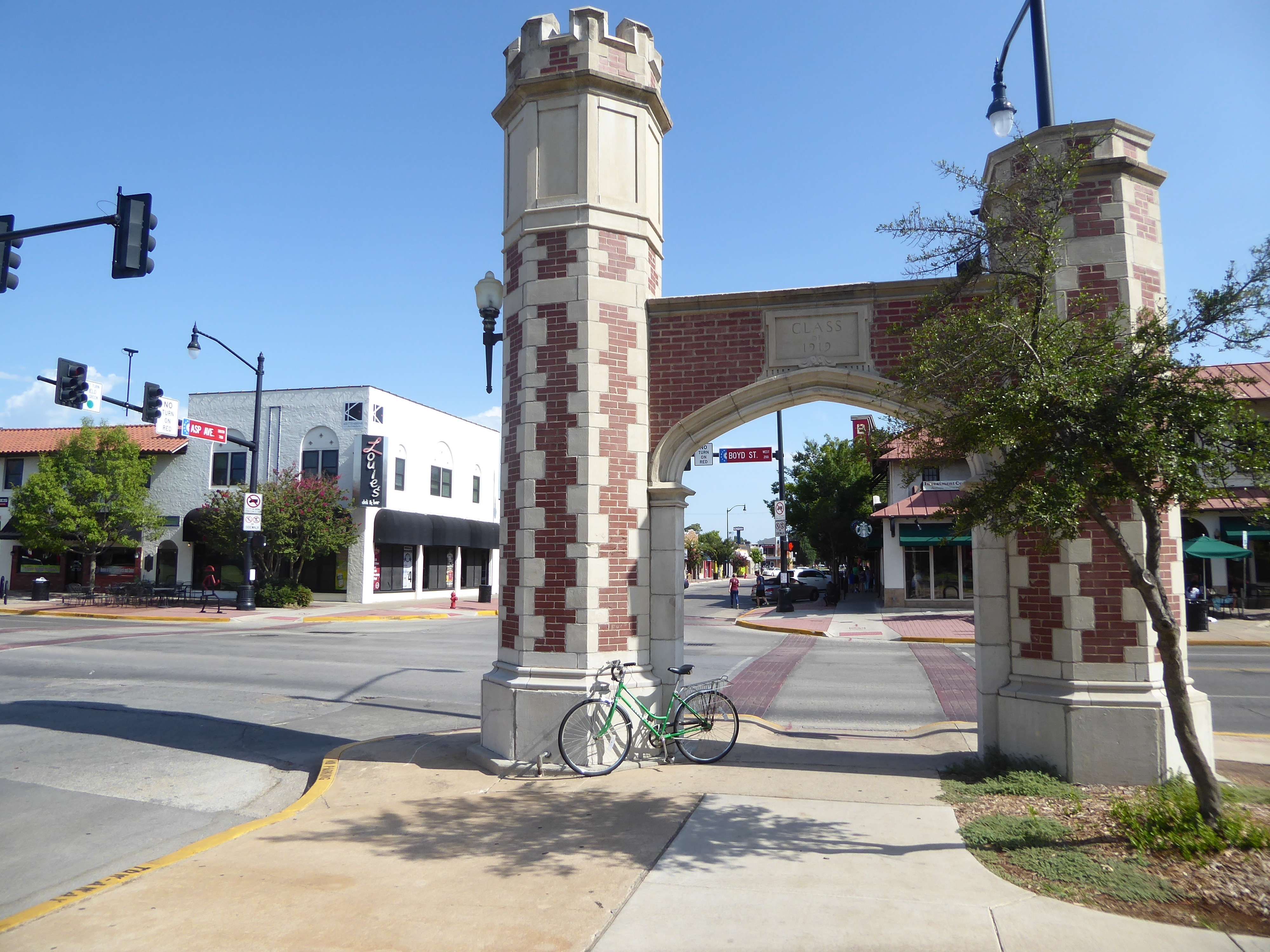 Back up on Campus Corner, we have the iconic gateways given by the class of 1919. And who's across the street? But who else?